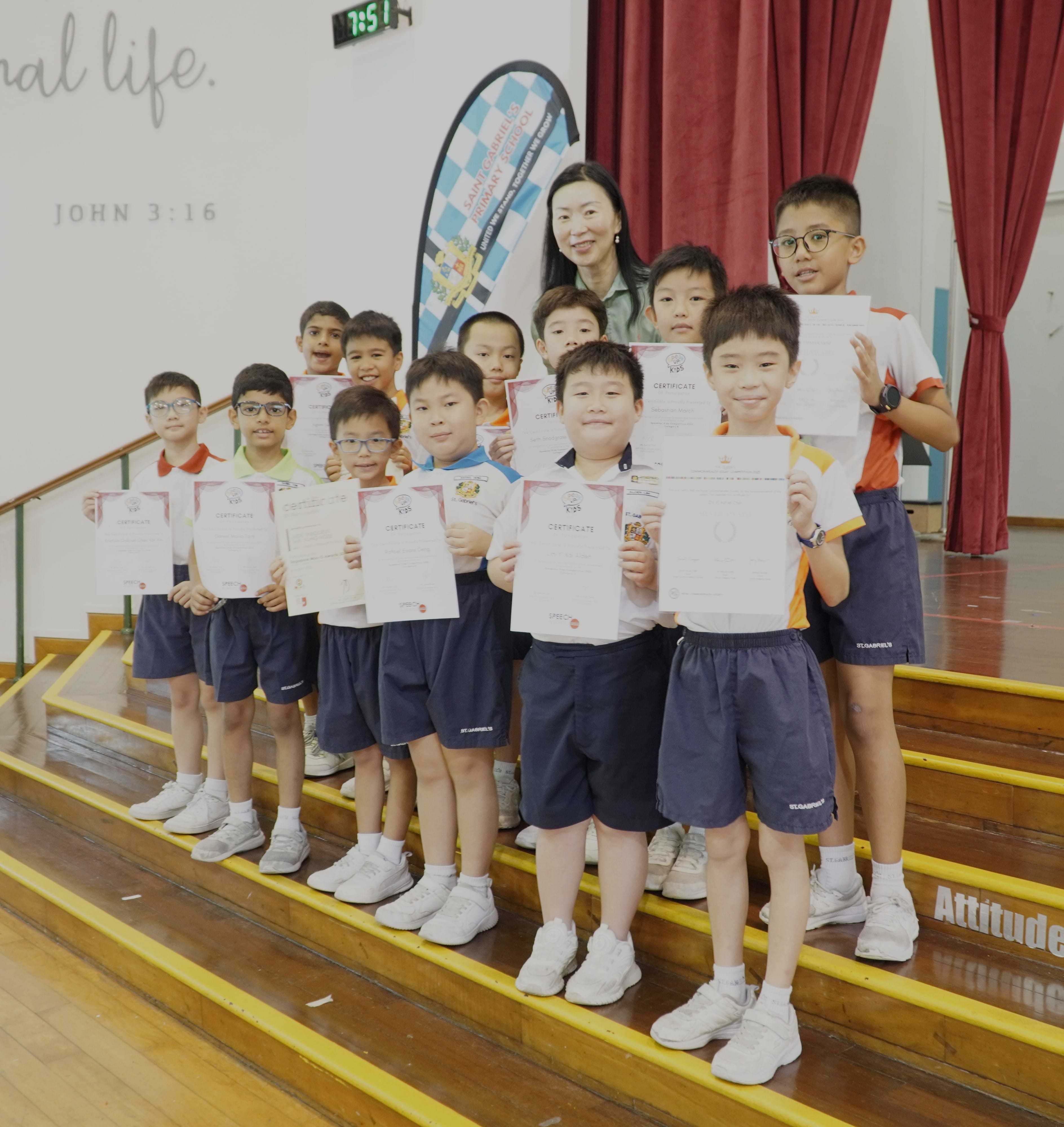 Twelve student winners taking a photo with the school's Vice-Principal