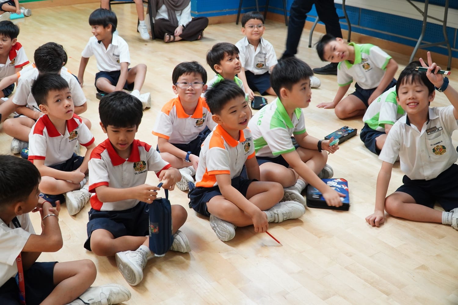 A group of students sitting on the floor having fun during lesson