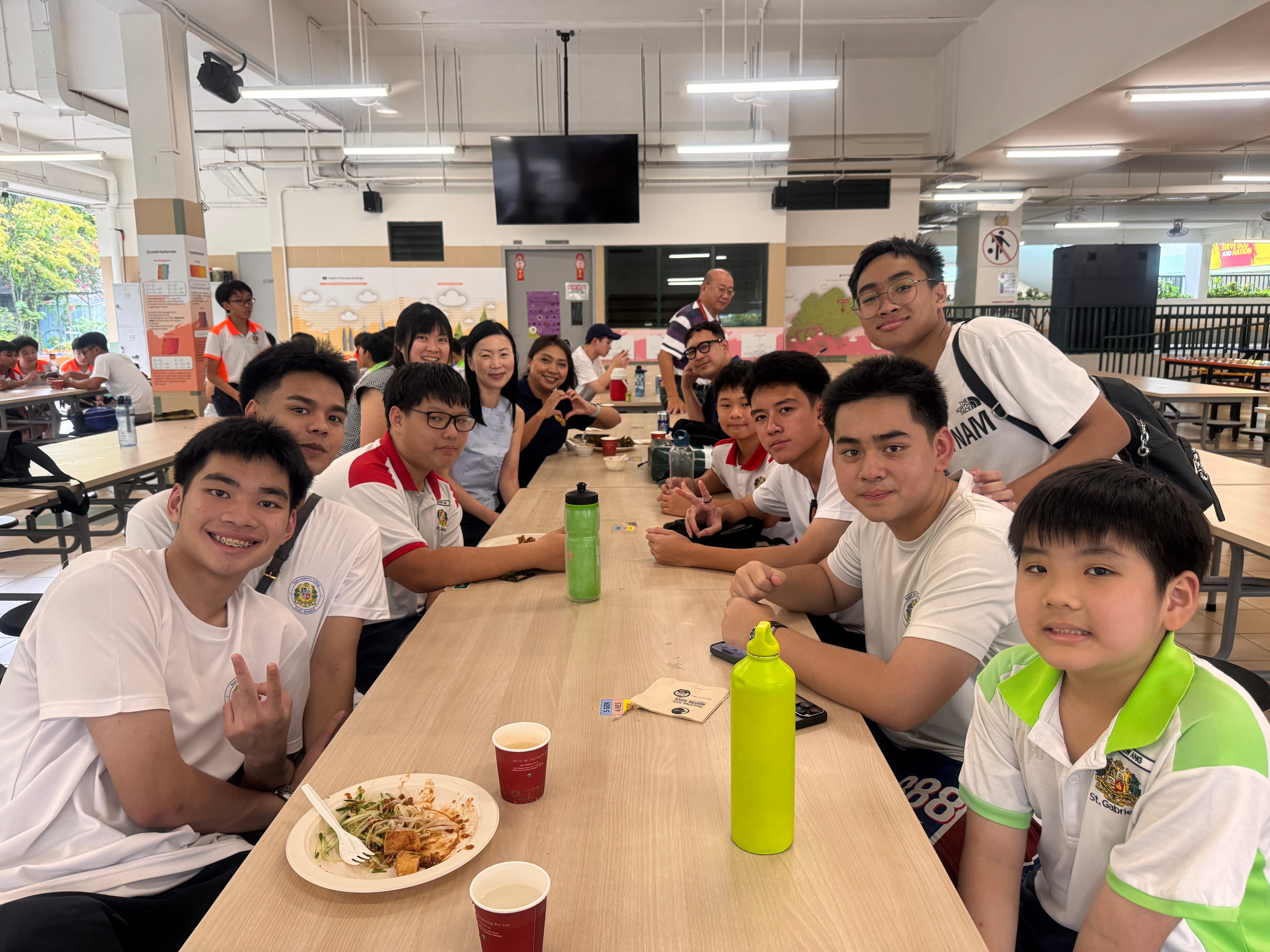 Thai students having a conversation with the teachers and vice-principal