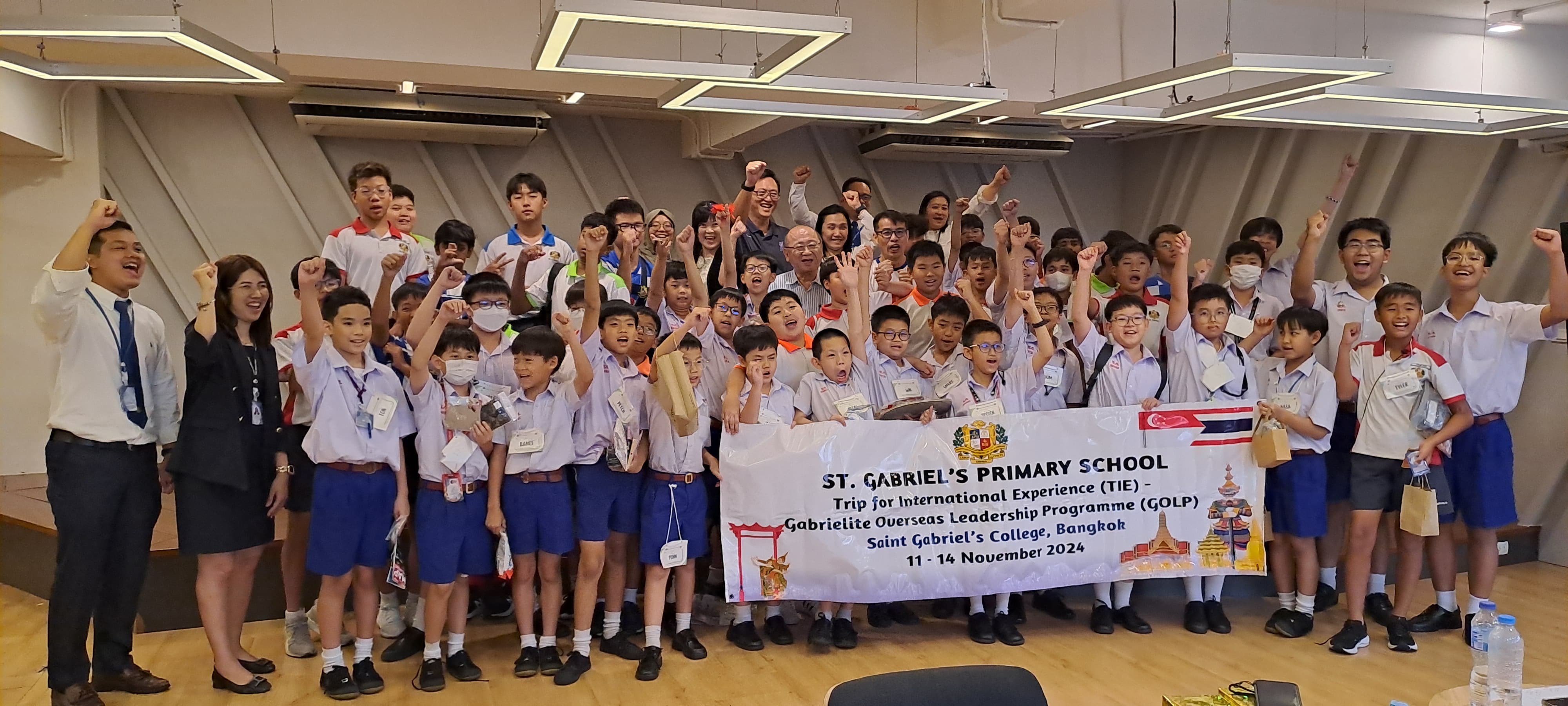 Group photo of students and teachers cheering