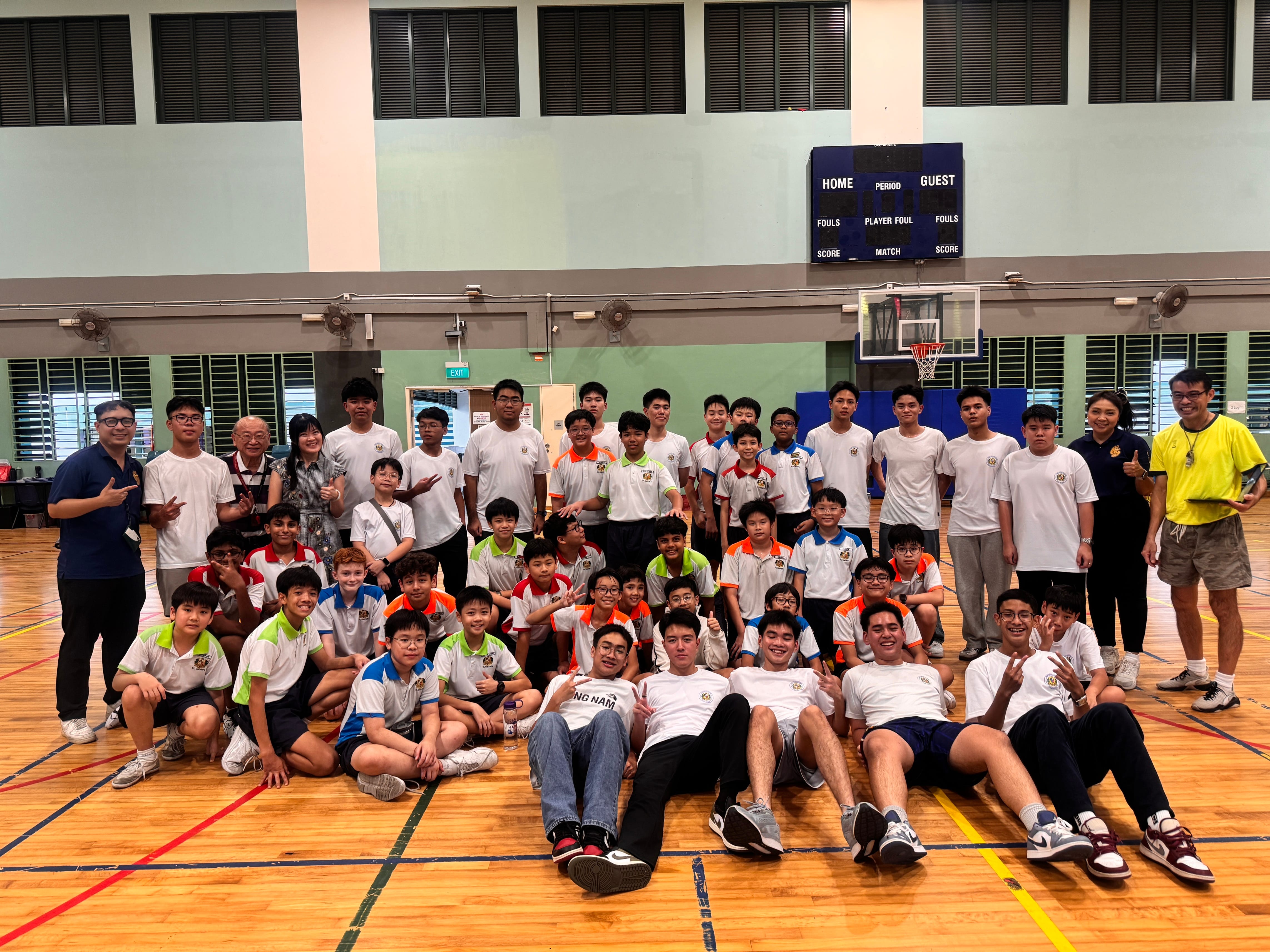 Group photo of the students and teachers in the indoor sports hall