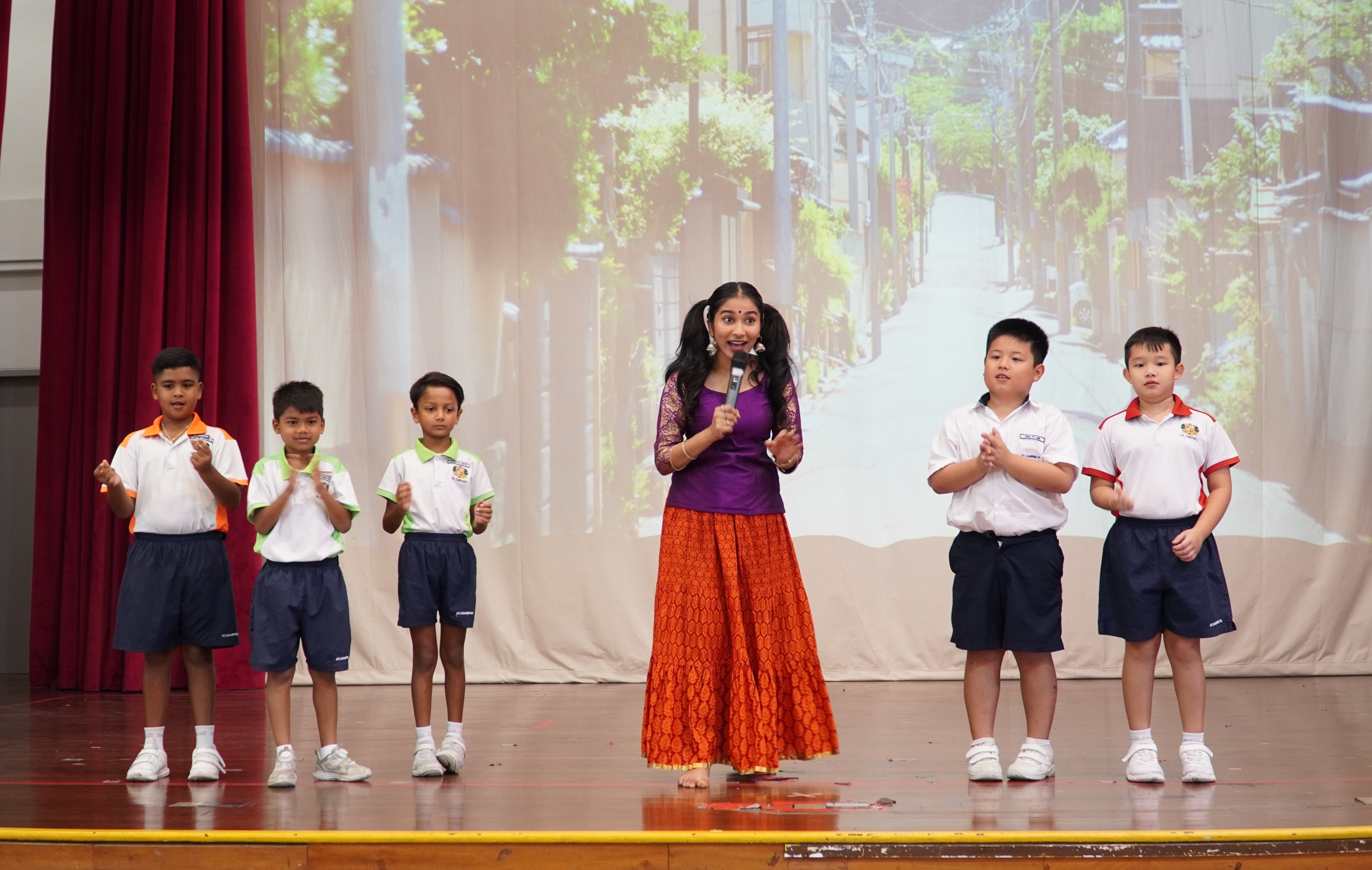 Five students participating in the Deepavali activity on stage
