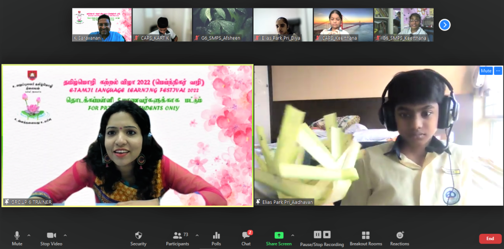 A Zoom meeting for Tamil Language Learning Festival 2022 showing a woman trainer and a student holding green leaves.