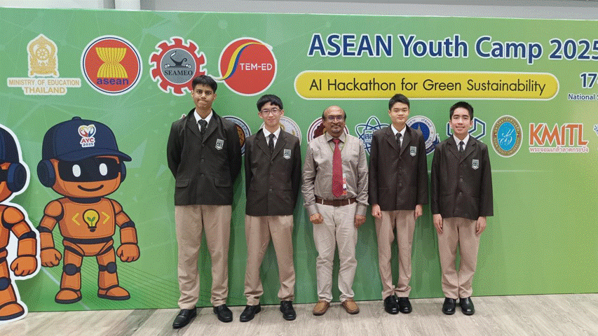 Five people pose in front of an ASEAN Youth Camp 2025 AI Hackathon for Green Sustainability banner.