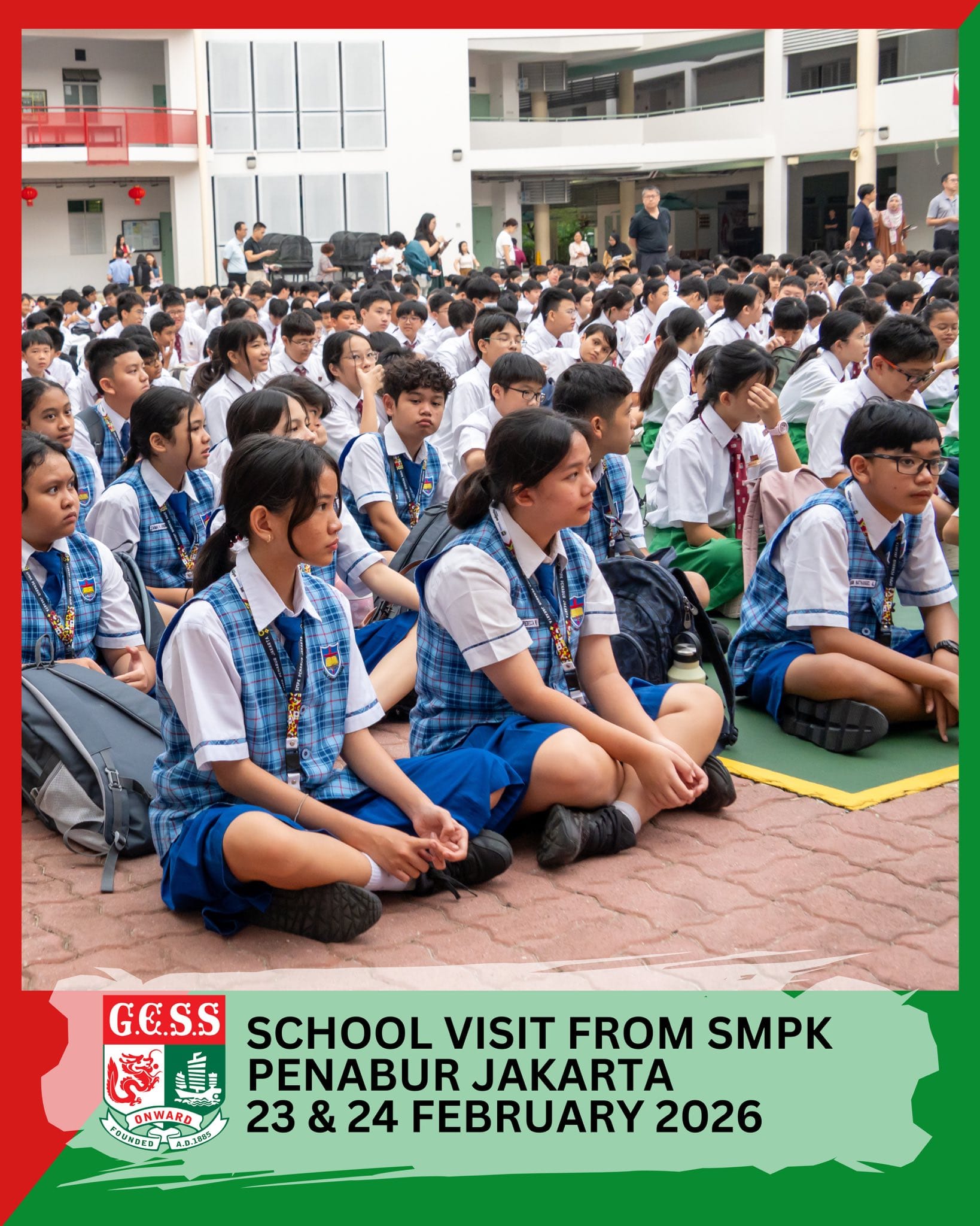 Students in blue plaid uniforms sit cross-legged in a school courtyard during a visit from SMPK Penabur Jakarta.