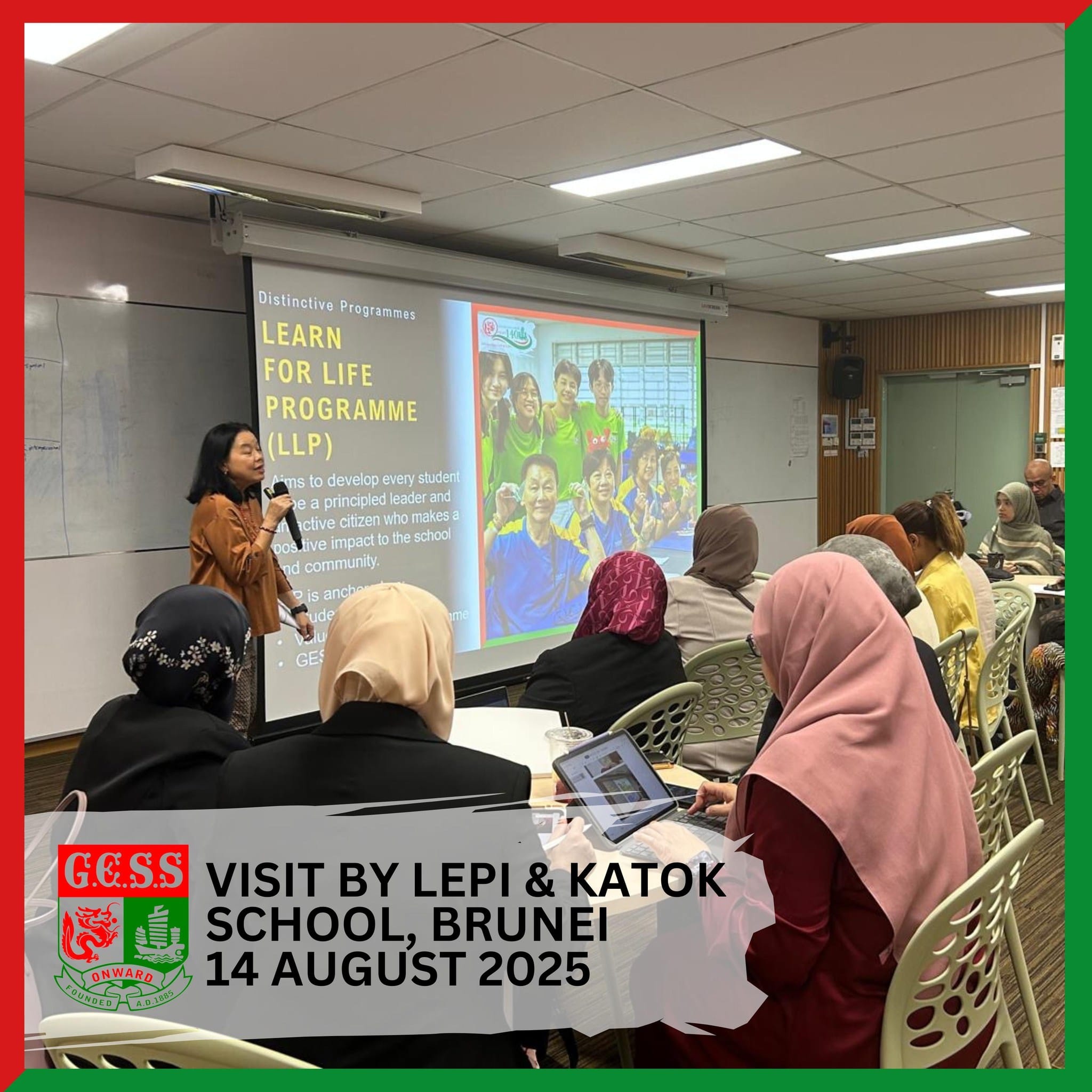 A woman presents a Learn for Life Programme slideshow to seated attendees during a school visit from Brunei.