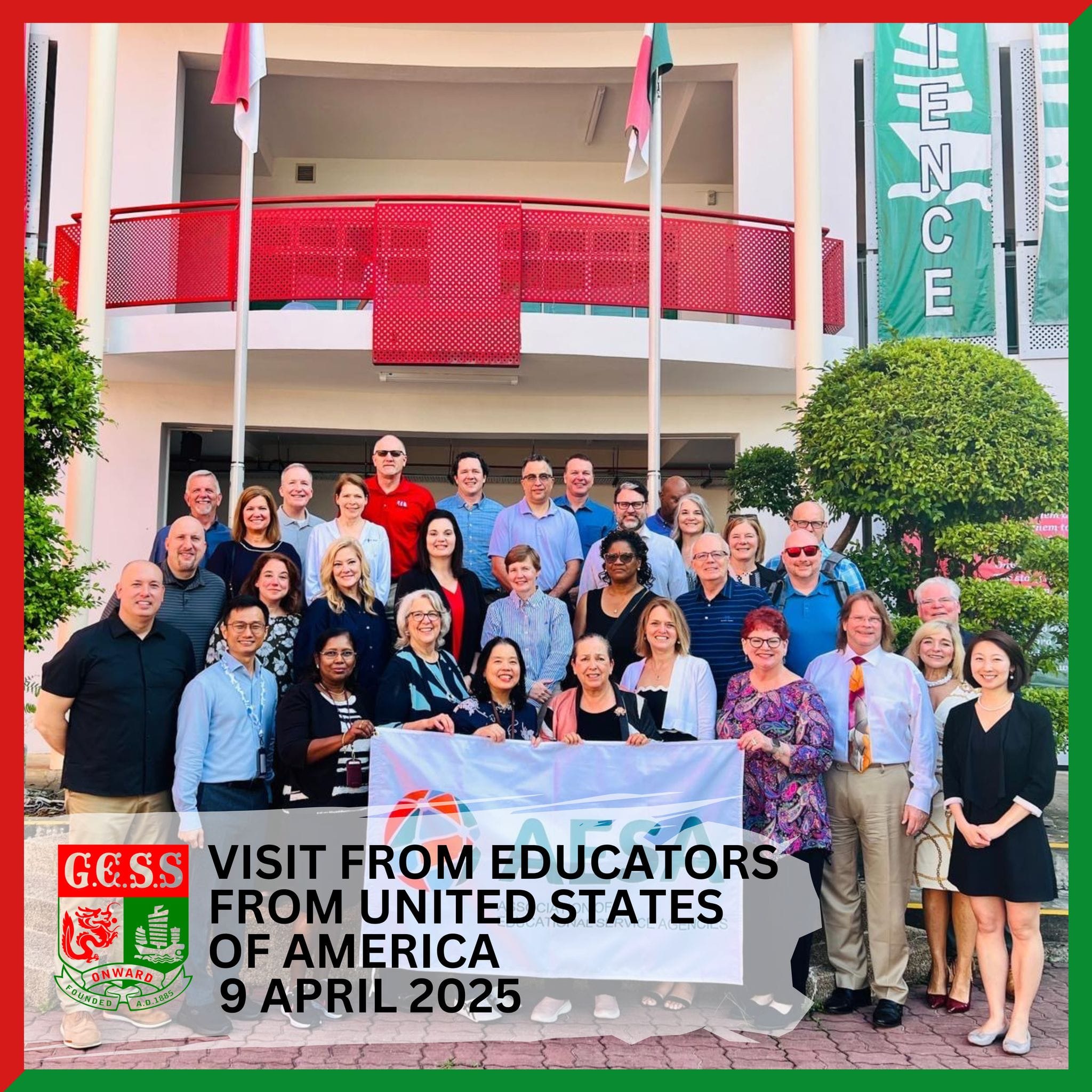 Group of educators from the USA posing outside GESS school on 9 April 2025, holding a banner.