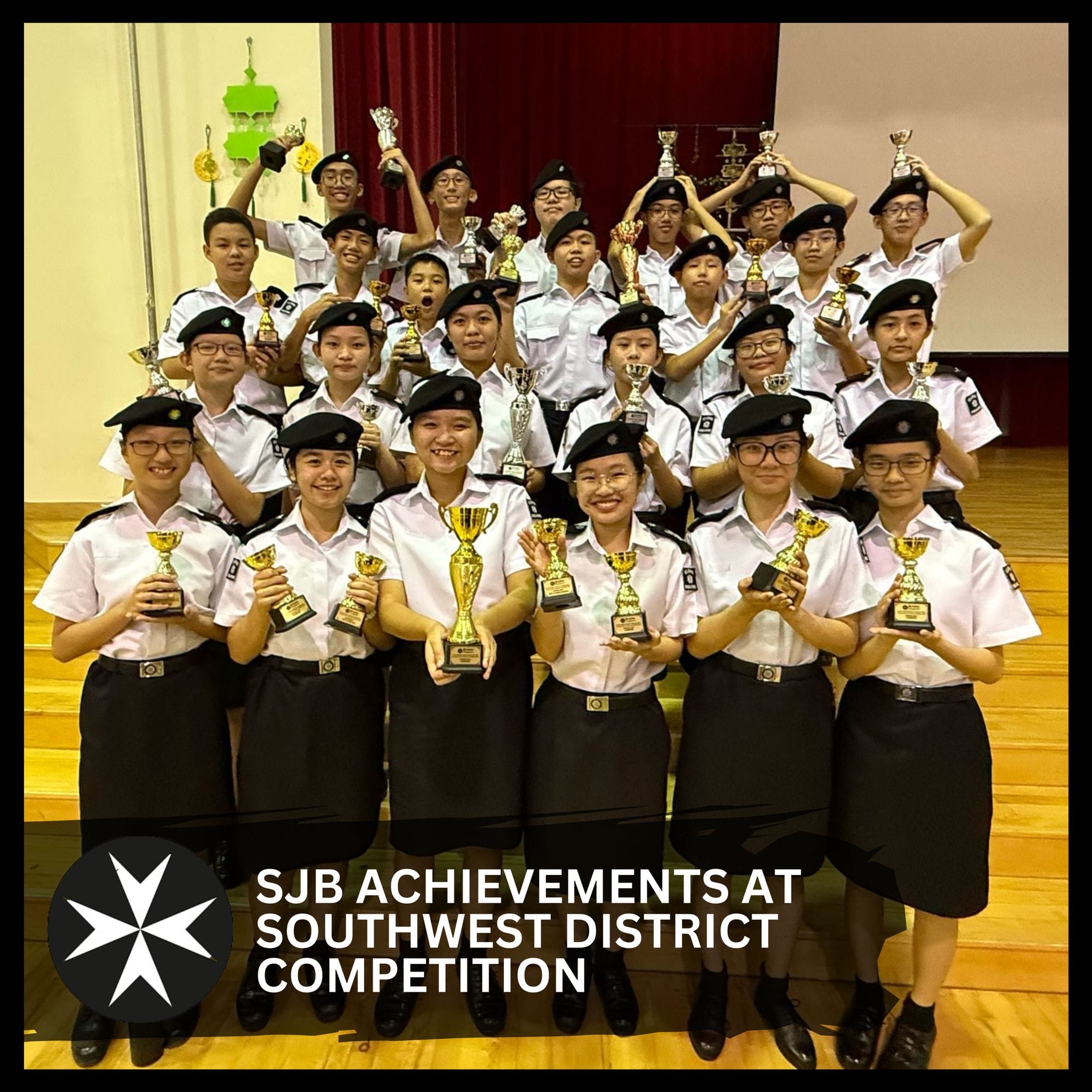A large group of uniformed students in black berets holding gold trophies, celebrating SJB Southwest District Competition wins.