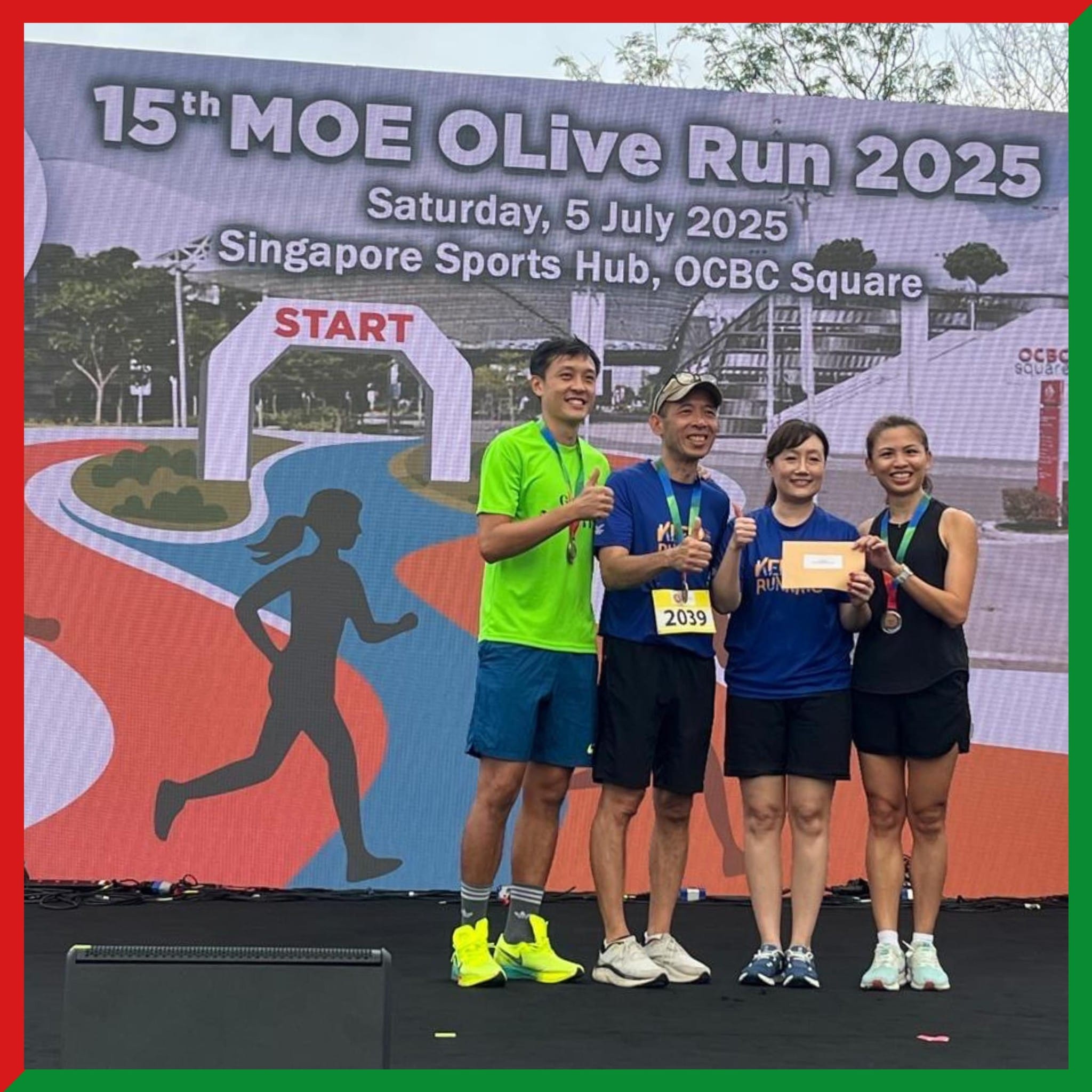 Four smiling runners with medals stand on a stage at the 15th MOE OLive Run 2025 banner backdrop.