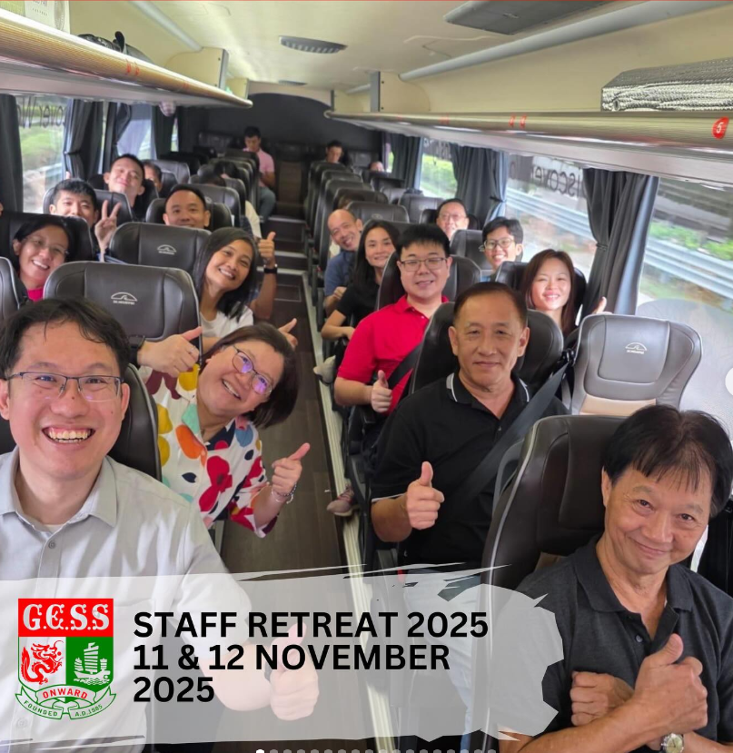A group of smiling staff members giving thumbs up on a coach bus for GCSS Staff Retreat, November 2025.