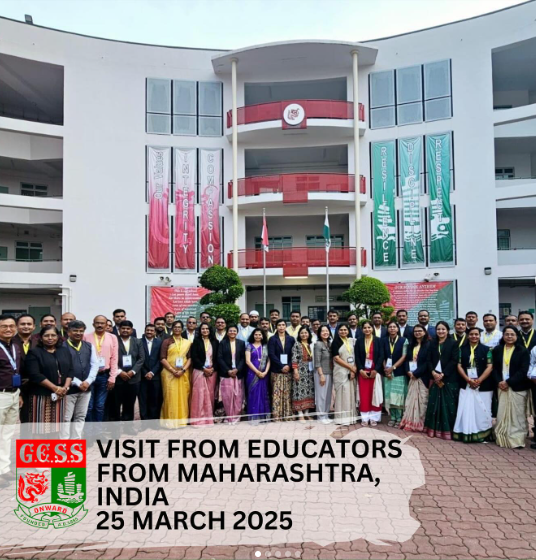 Large group of educators from Maharashtra, India posing in front of a modern building on 25 March 2025.
