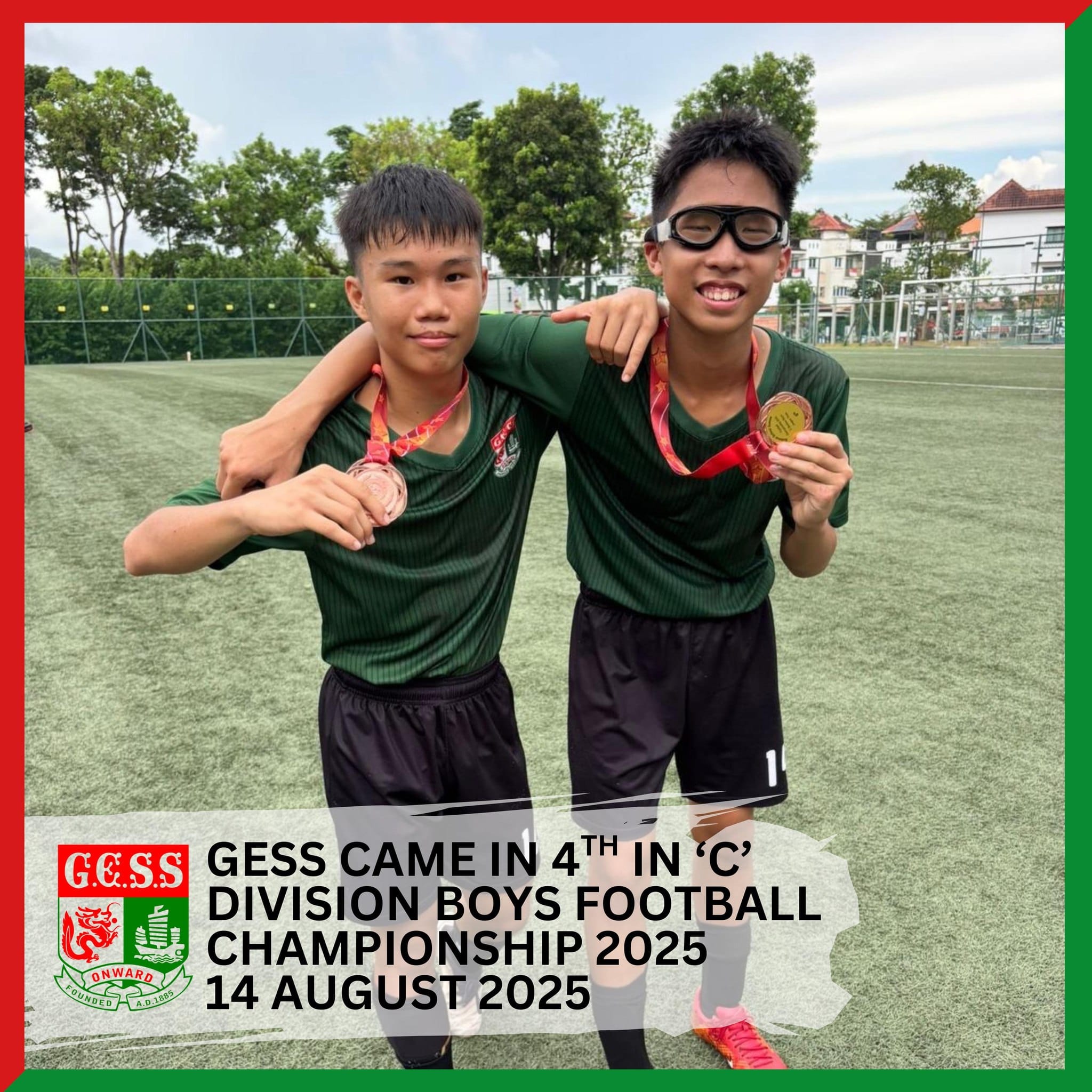 Two boys in green football jerseys hold medals on a field, celebrating GESS 4th place finish in 2025 championship.