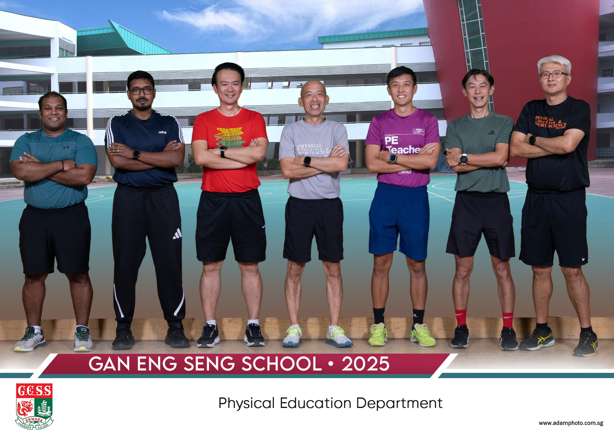 Seven men in sportswear stand with arms crossed outdoors at Gan Eng Seng School Physical Education Department, 2025.
