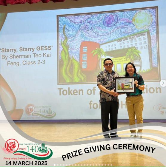 Two people hold a framed artwork on stage at Gan Eng Seng School Prize Giving Ceremony on 14 March 2025.