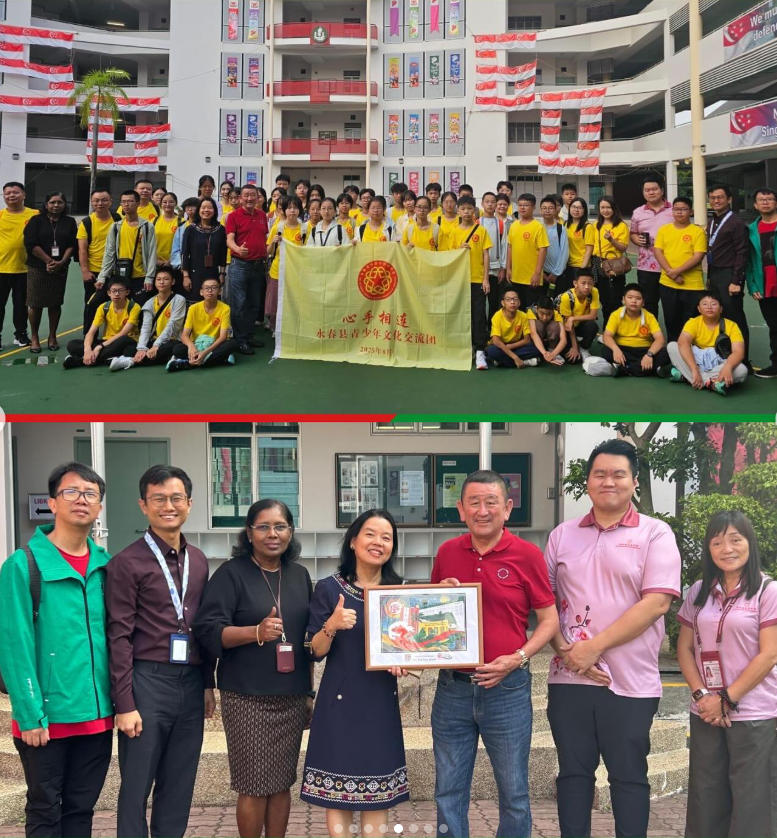 Large group of students in yellow shirts pose with a banner at a school, below adults exchange a framed artwork gift.