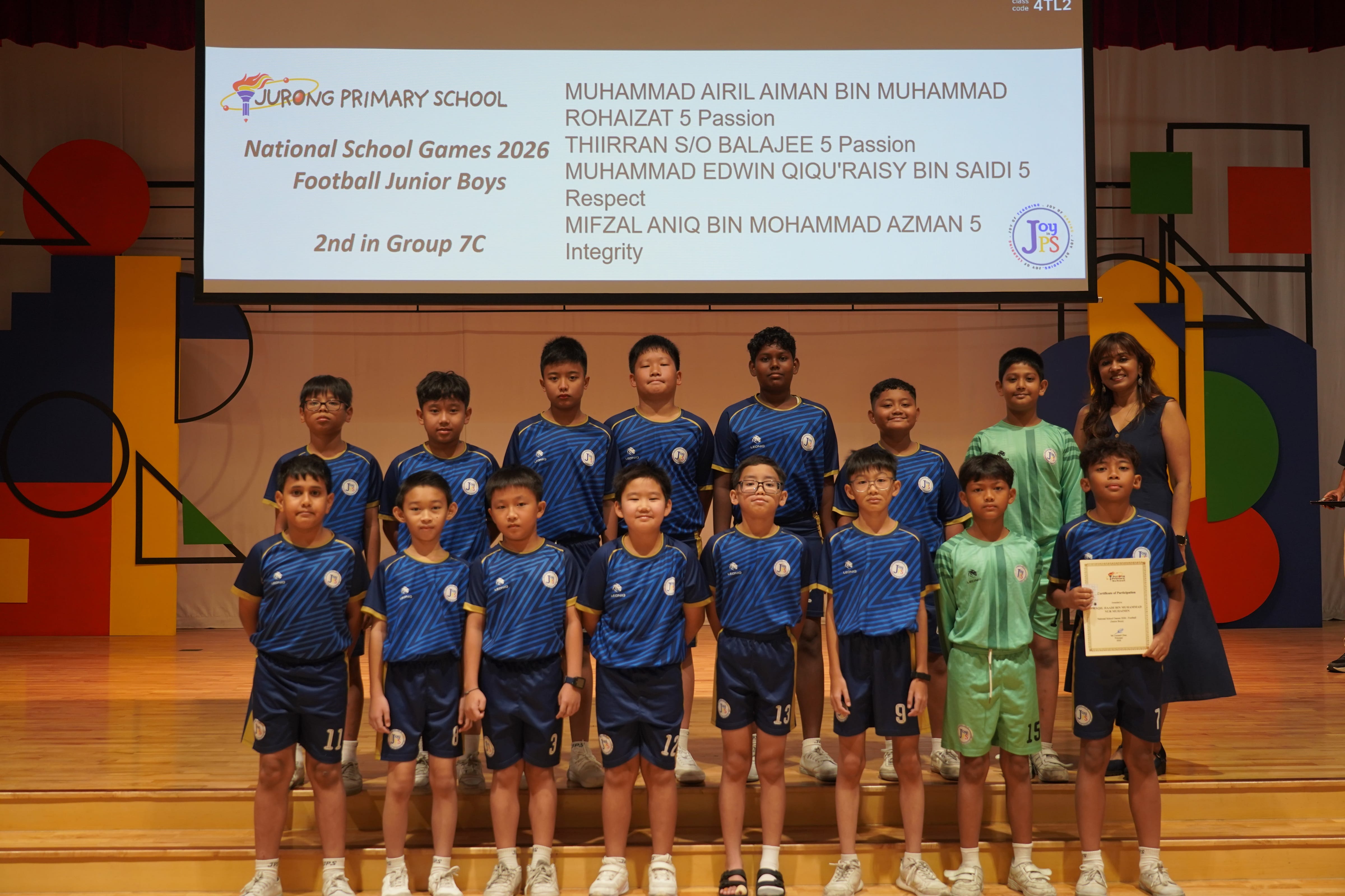 Twelve boys in football jerseys with a certificate and Vice-Principal, National School Games 2026 Football Junior Boys, 2nd in Group 7C.