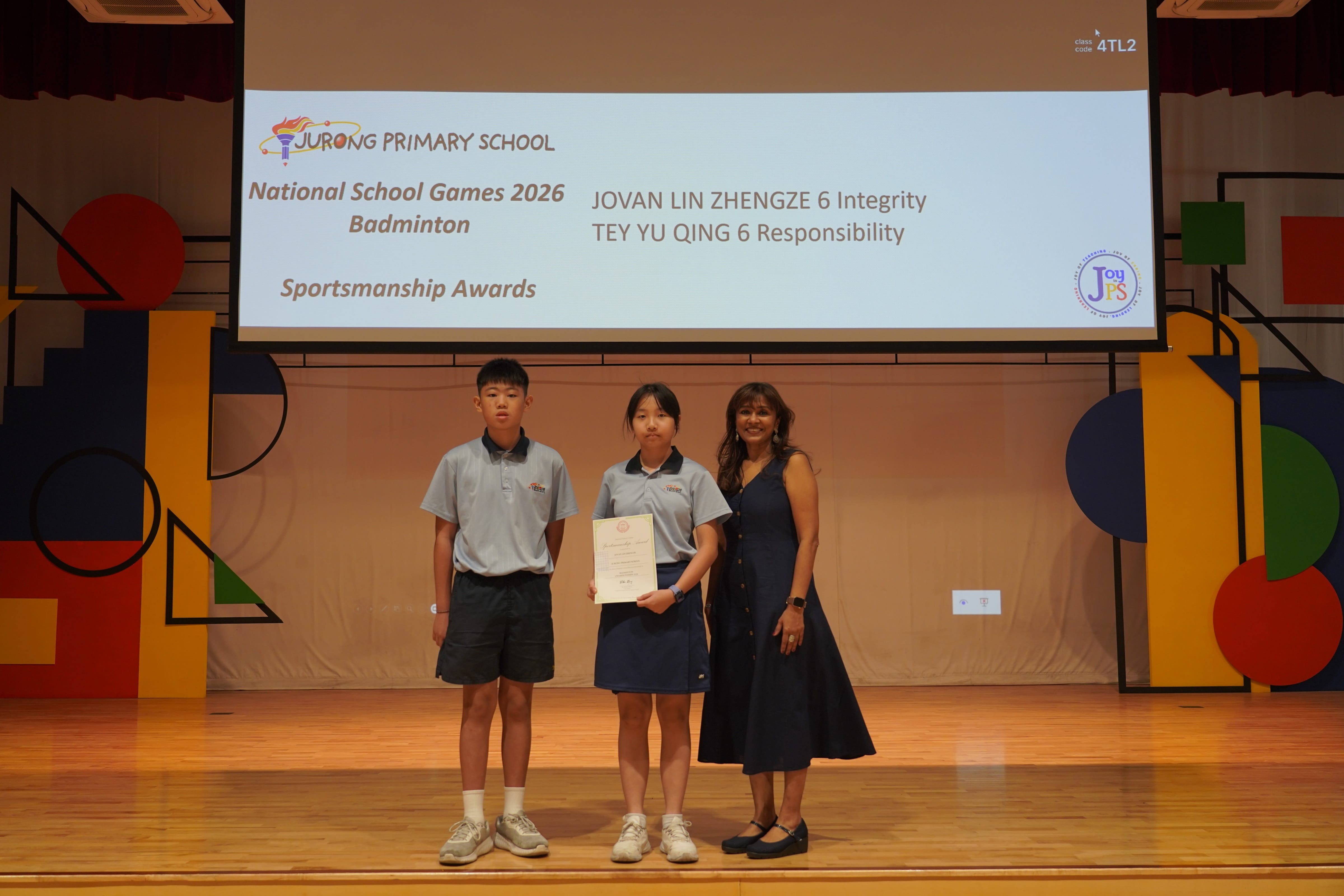 Two students with a certificate and Vice-Principal, National School Games 2026 Badminton Sportsmanship Award.