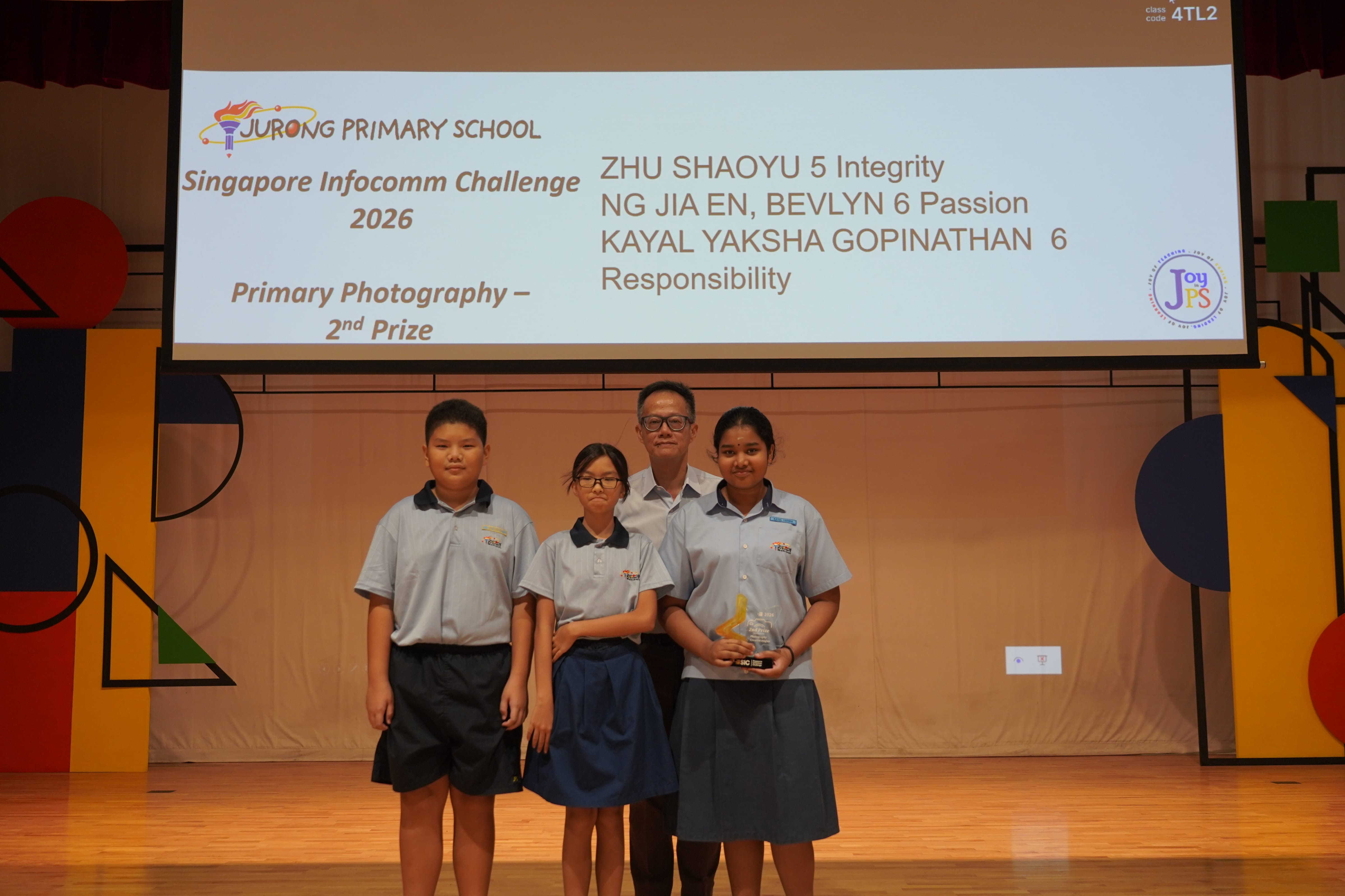 Three students with a trophy and Vice-Principal, Singapore Infocomm Challenge 2026 Photography 2nd Prize.