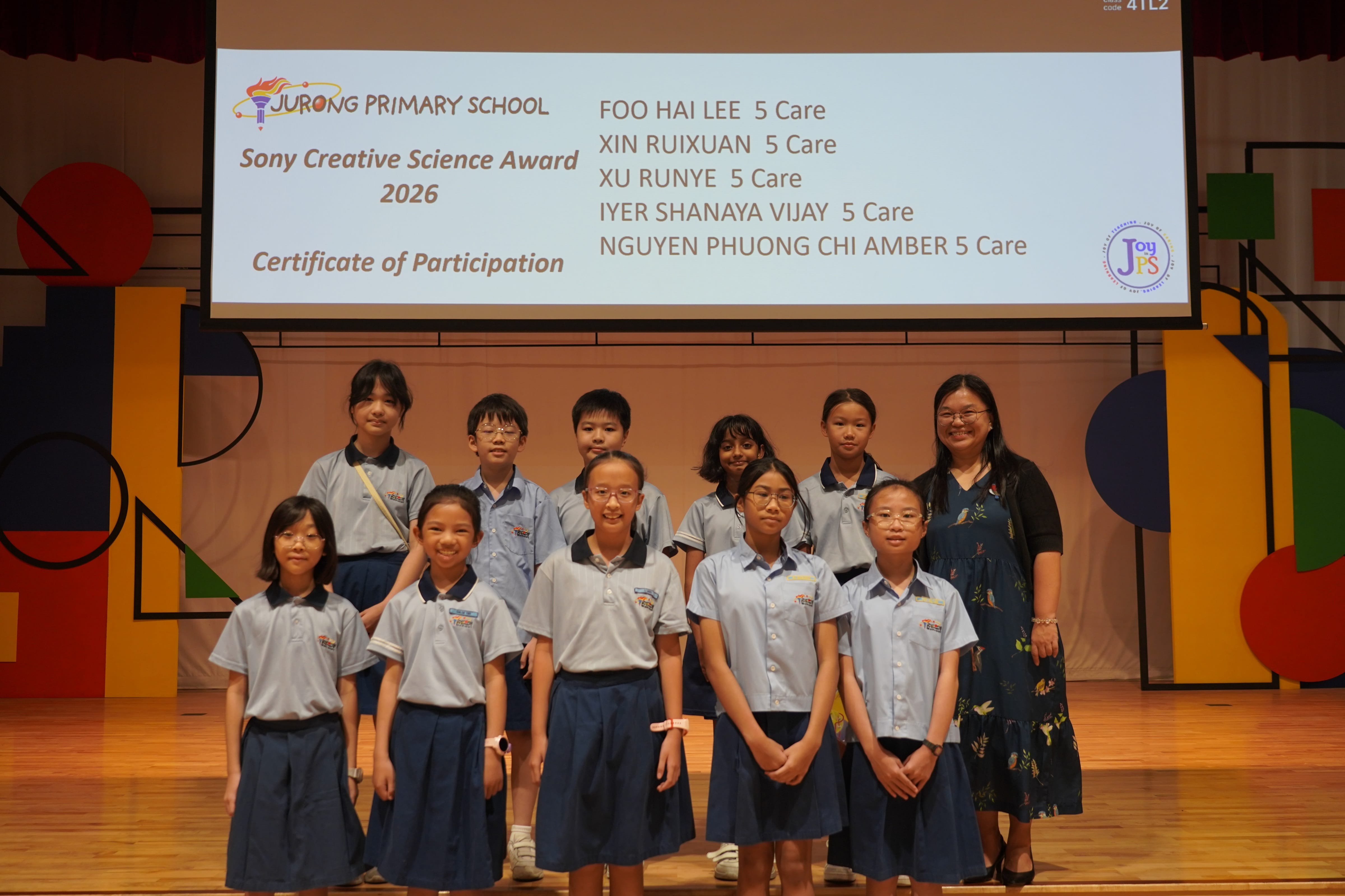 Ten students posing with a VIce-Principal on stage, Sony Creative Science Award 2026.