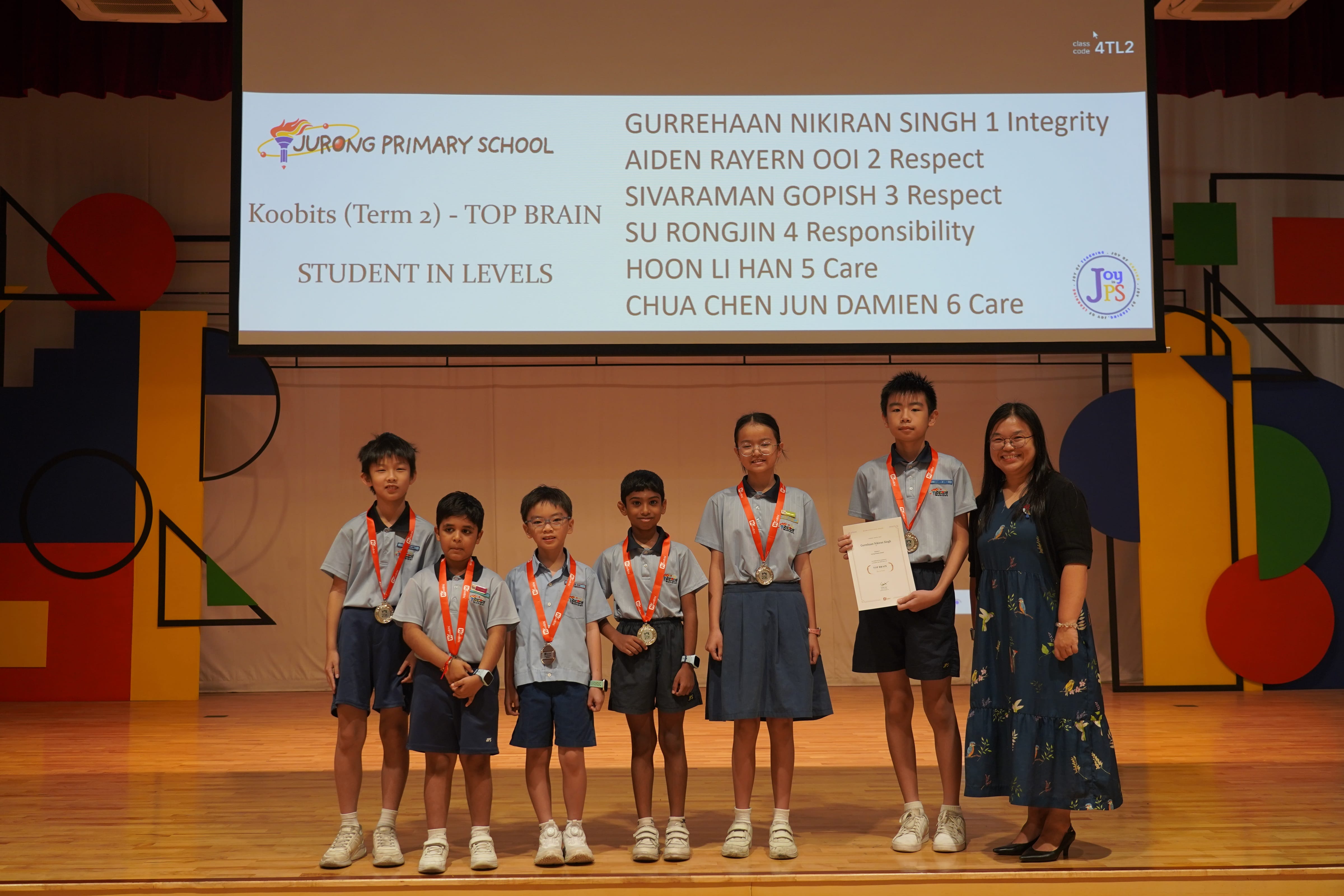 Six students with medals and a certificate with a Vice-Principal, Koobits Top Brain award.
