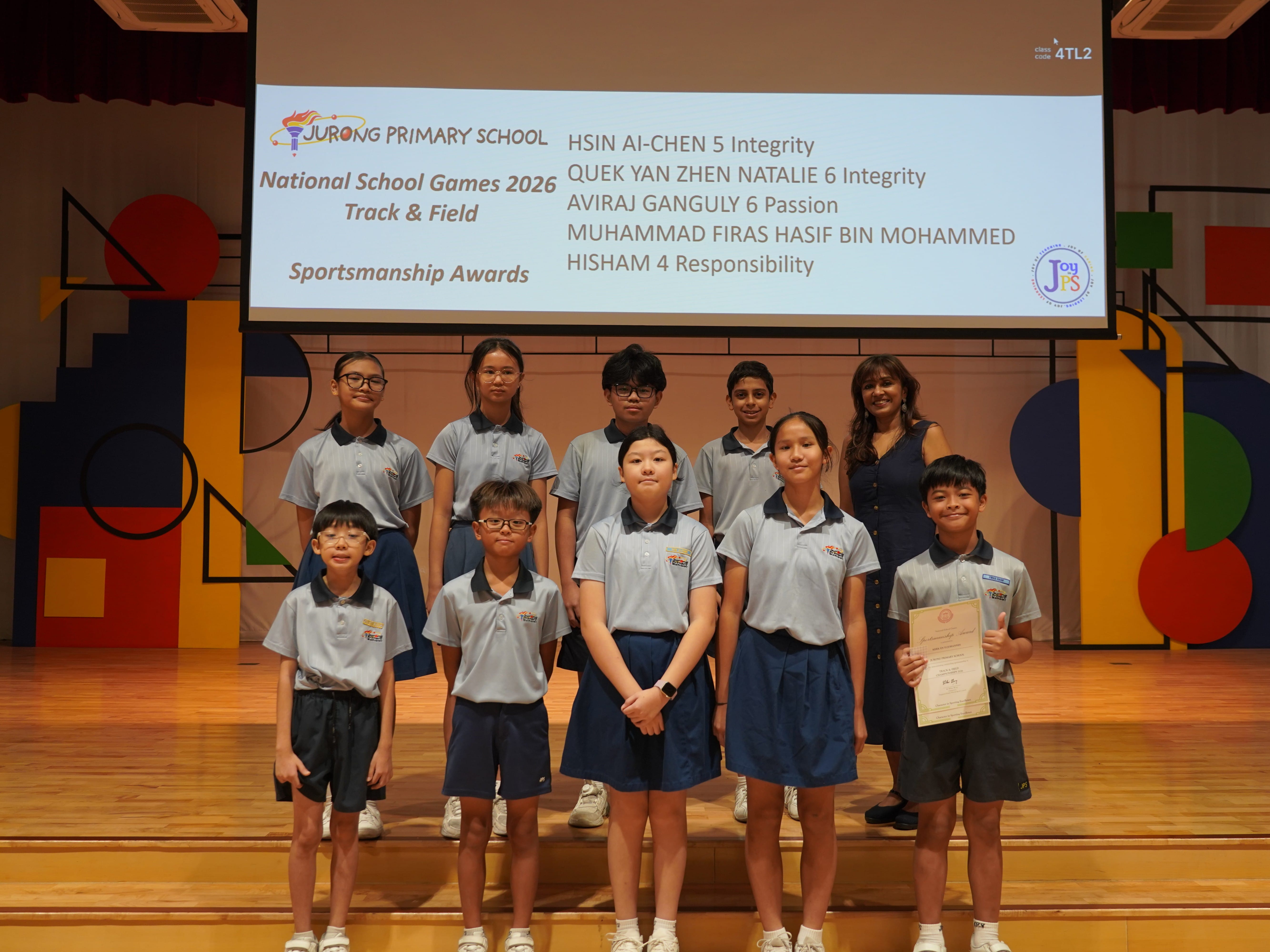 Nine students with a certificate and Vice-Principal, National School Games 2026 Track & Field Sportsmanship Award.
