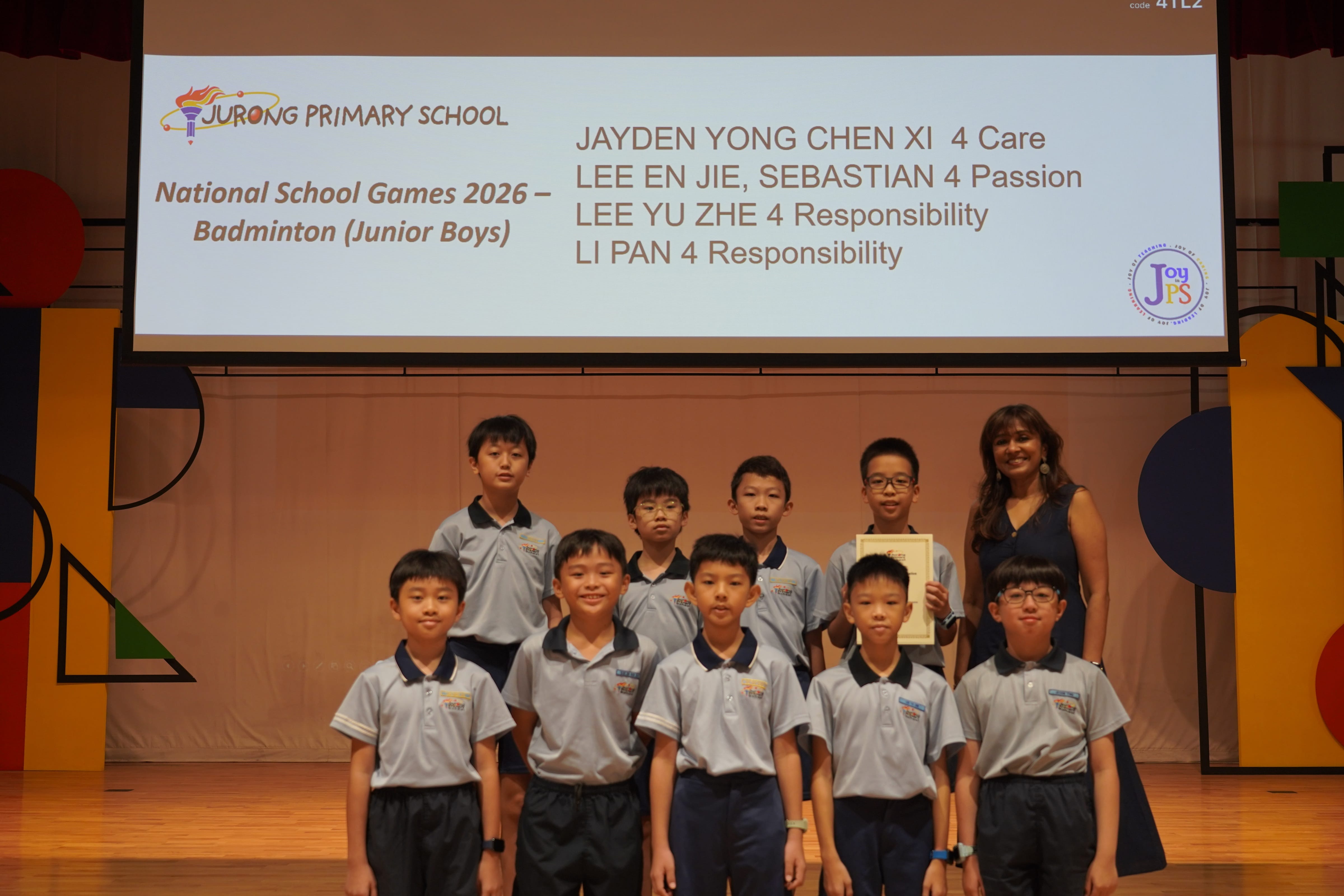 Eight boys with a certificate and Vice-Principal, National School Games 2026 Badminton Junior Boys award.