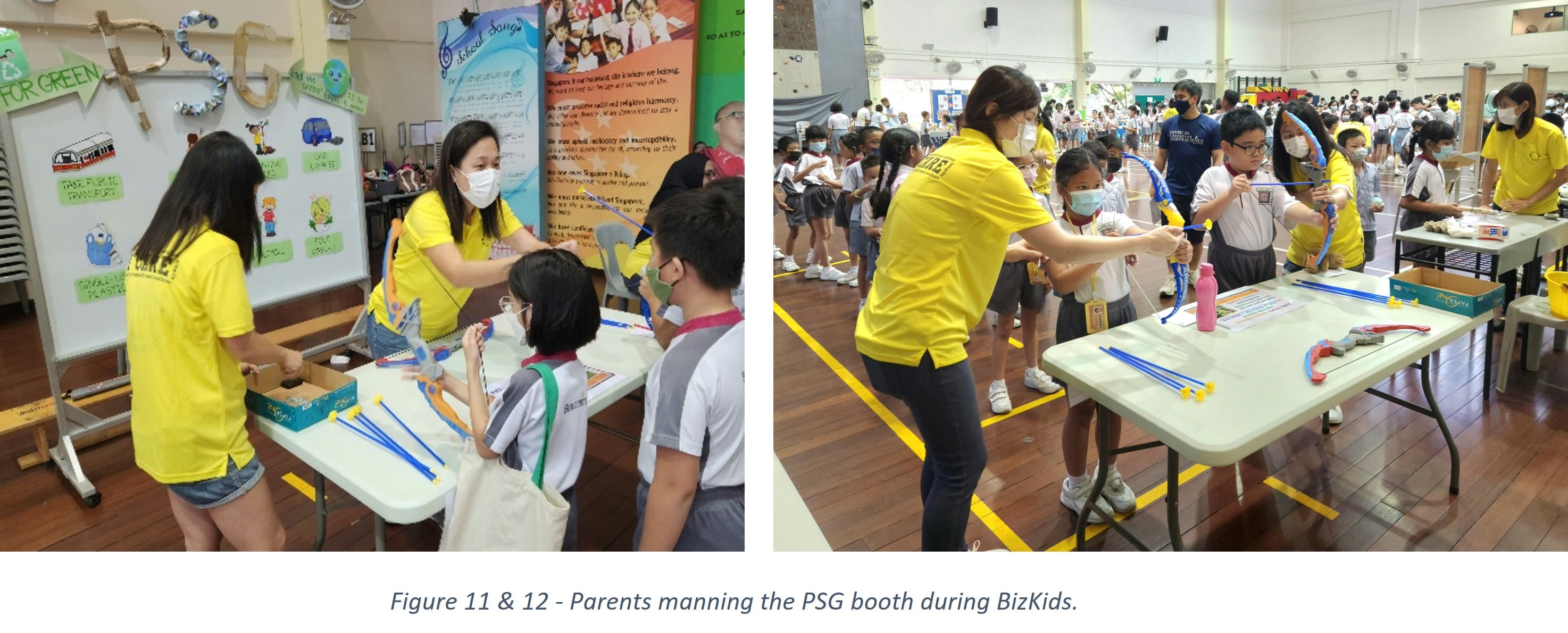 Adults in yellow shirts wearing masks run activity booths for school children in a hall during a BizKids event.