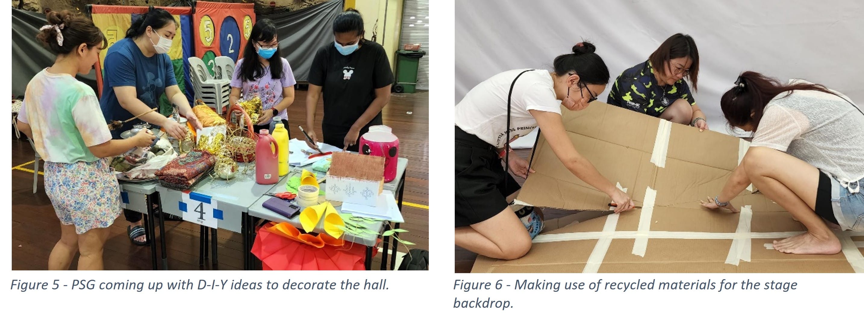 Four masked people craft decorations at a table; three others tape large cardboard pieces on the floor for a stage backdrop.