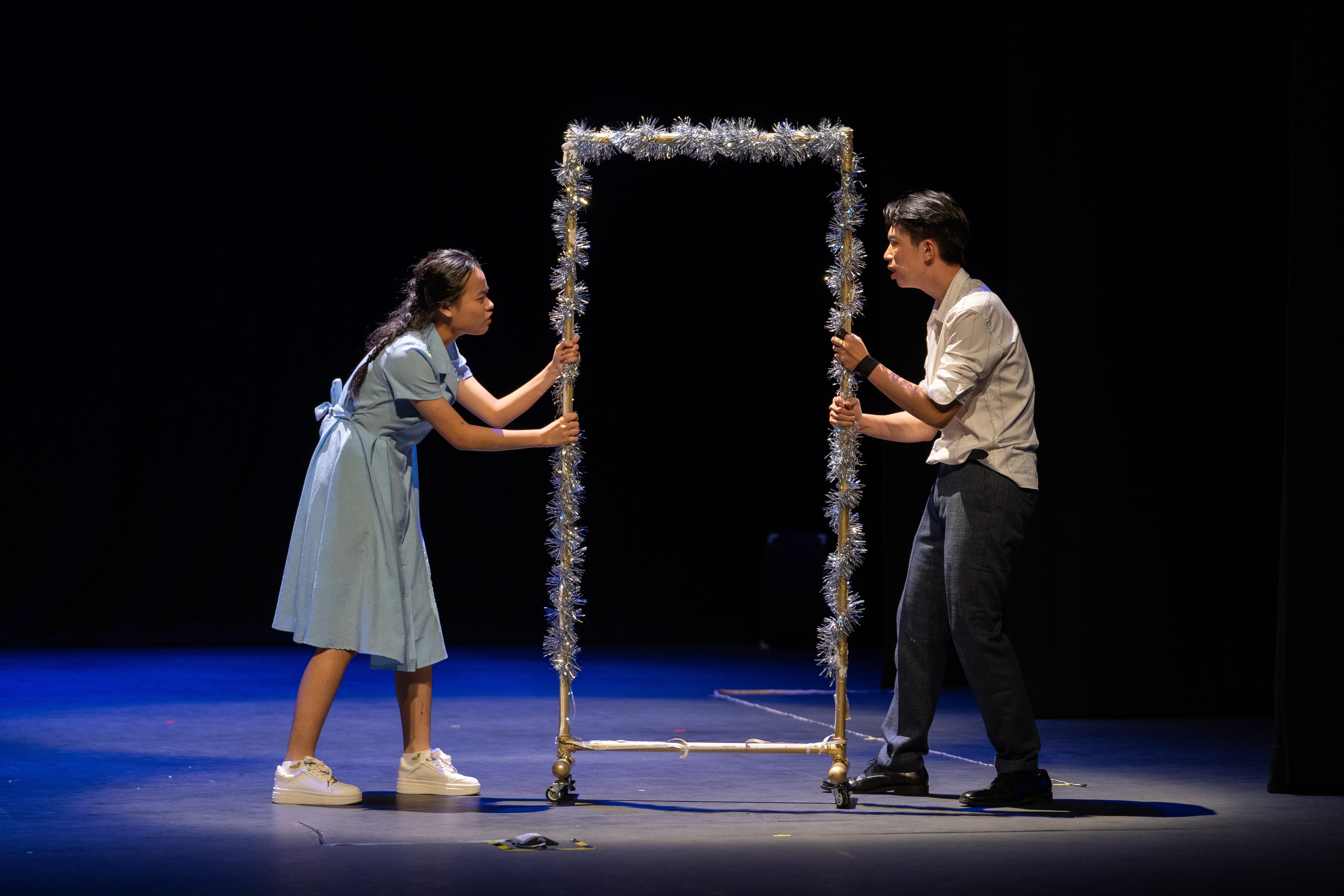 two students holding a door