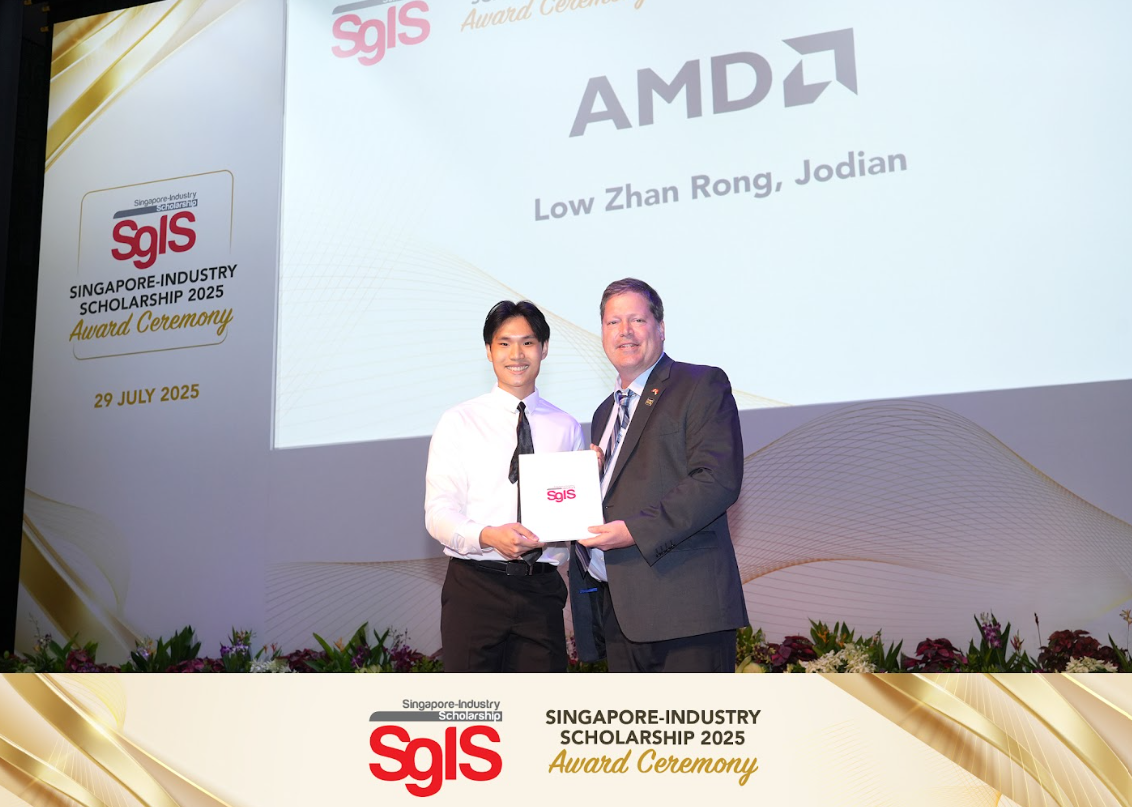 Two men hold a certificate on stage at the Singapore-Industry Scholarship 2025 Award Ceremony sponsored by AMD.