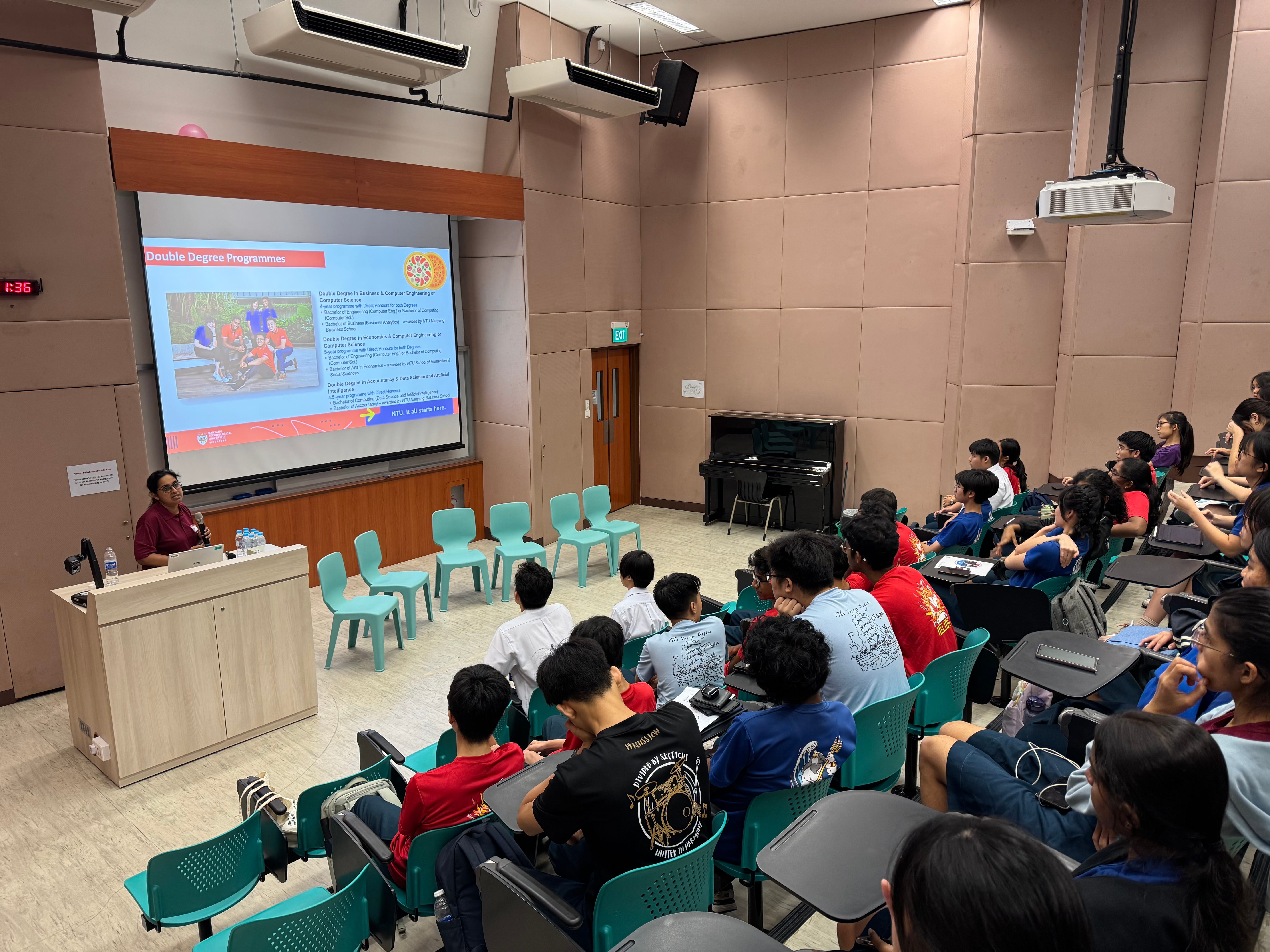 Lecture hall with seated students watching a presenter beside a screen titled Double Degree Programmes.