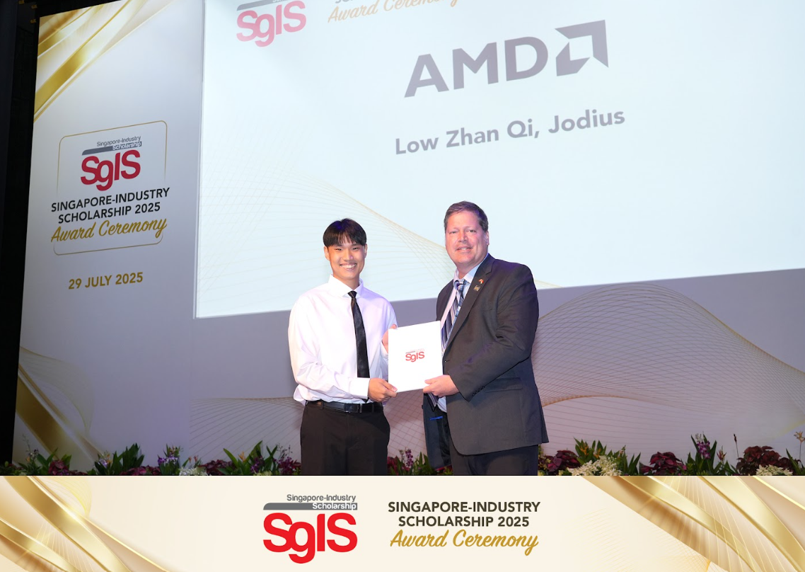Two men hold a certificate on stage at the Singapore-Industry Scholarship 2025 Award Ceremony, with AMD branding visible.
