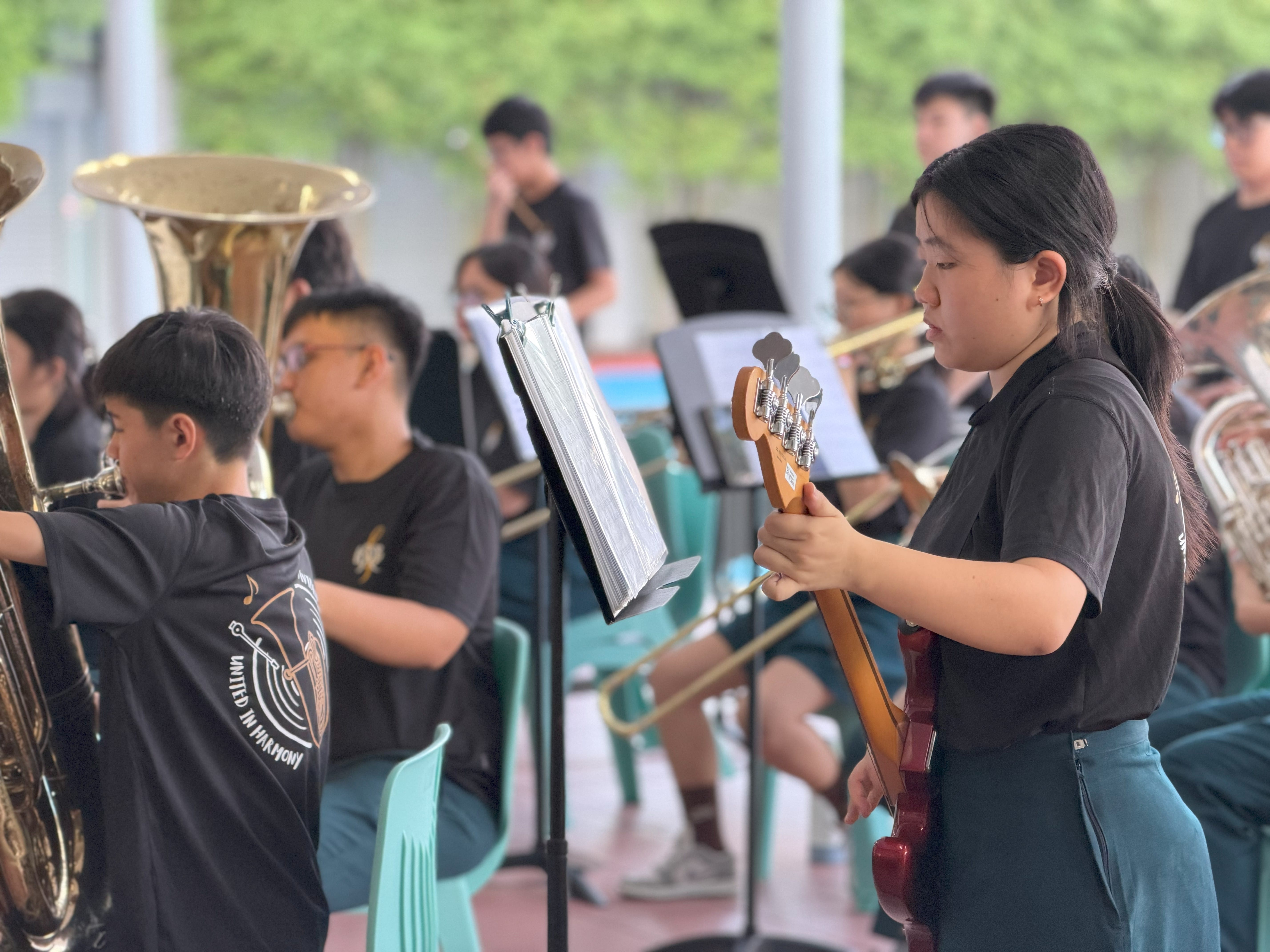 A female student plays the base with the college band