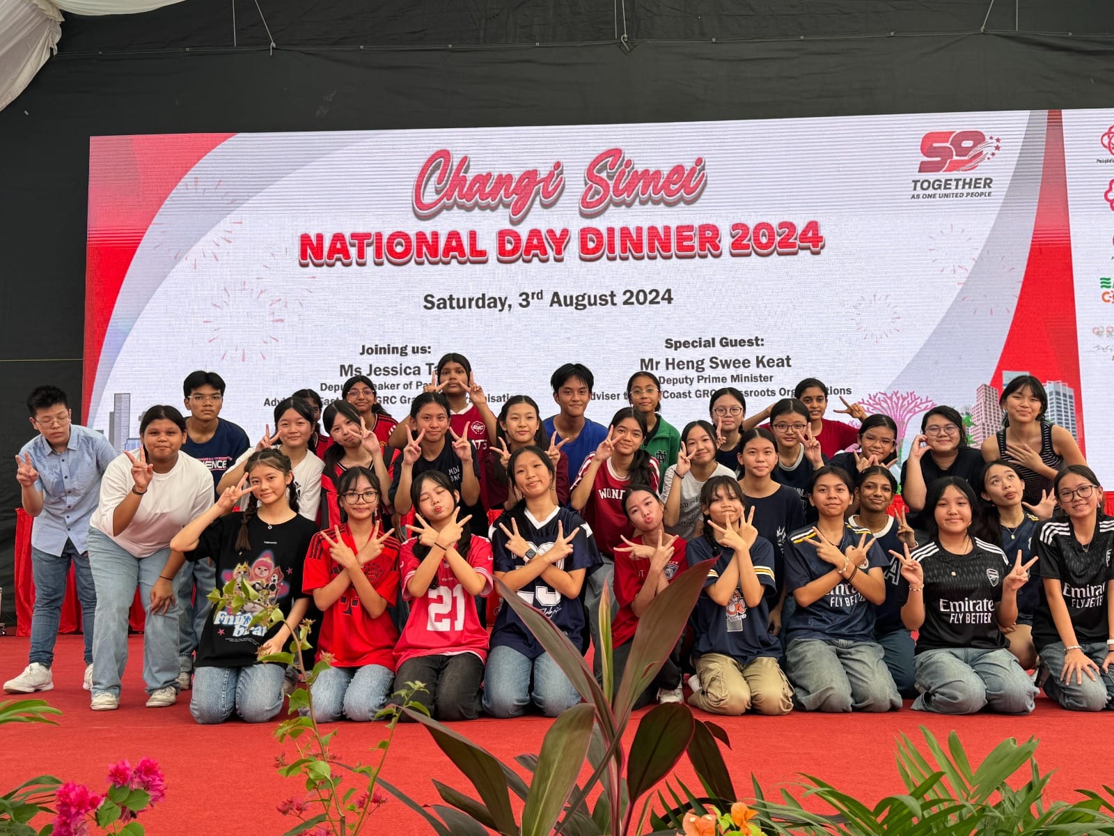 A group of young people pose with peace signs at the Changi Simei National Day Dinner 2024 on 3 August.