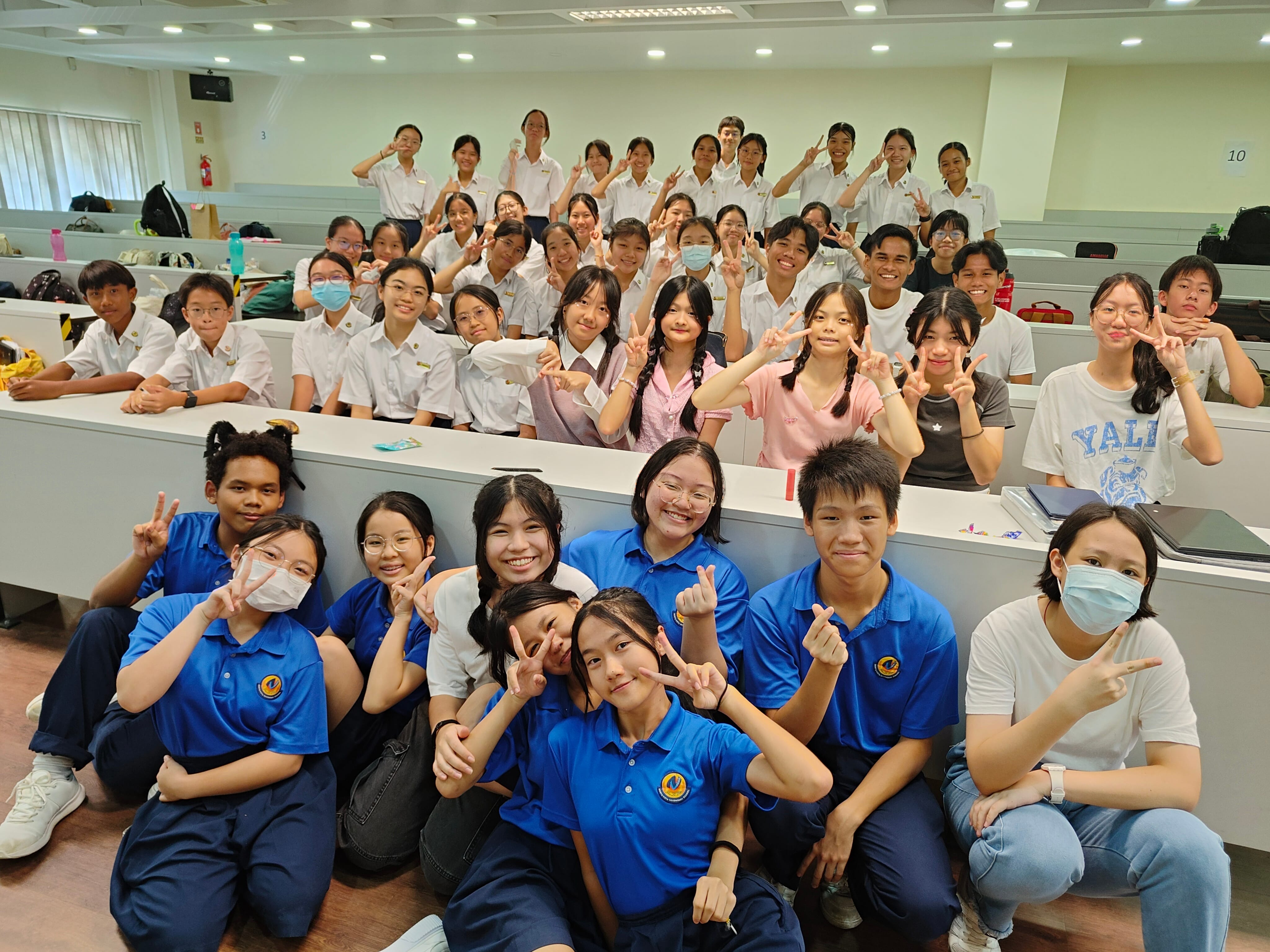 NV Class Committee members posing in the school's lecture theatre