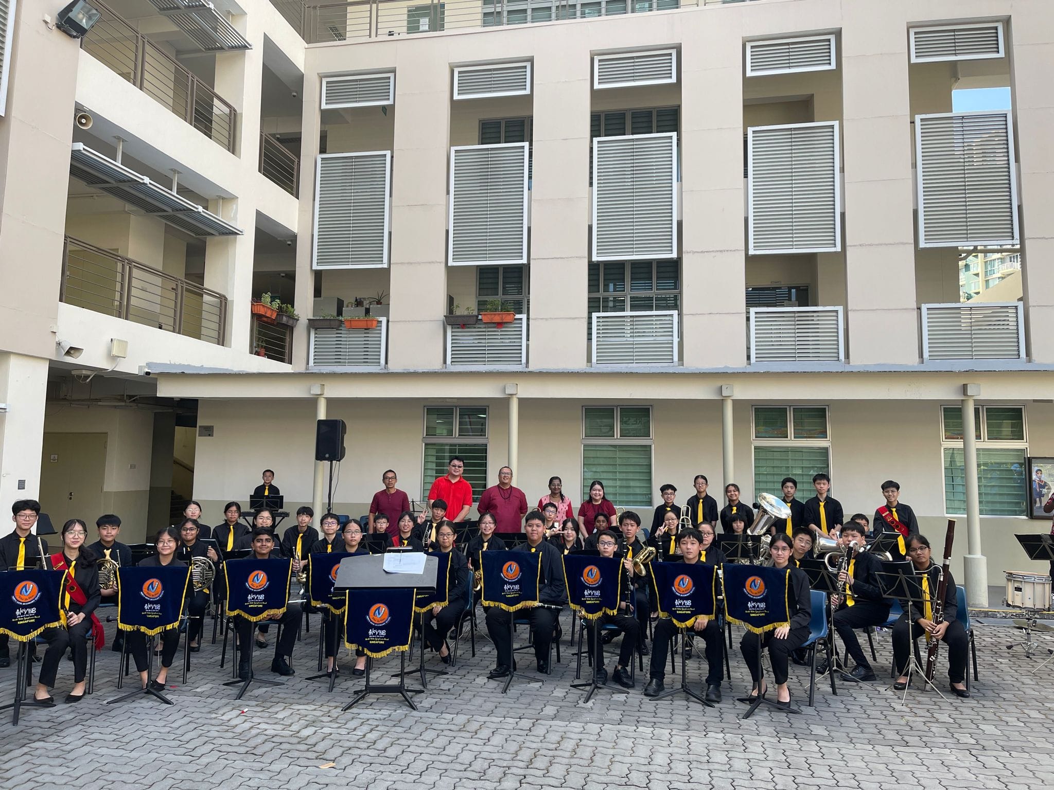 Band members perform outdoors during National Day Celebration