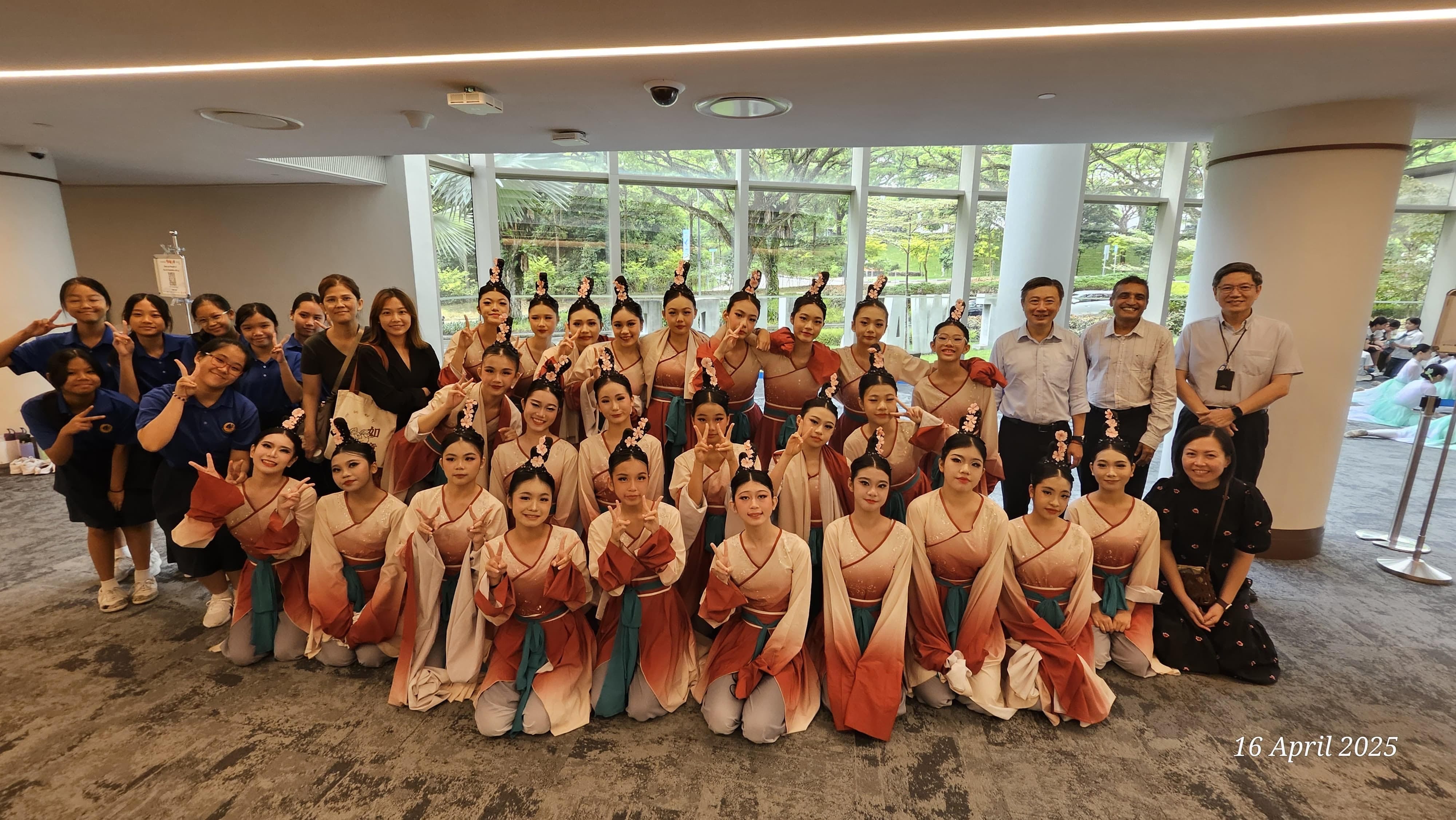 NV Chinese Dancers poses indoors on April 16, 2025, in traditional Chinese dance costumes with school leaders