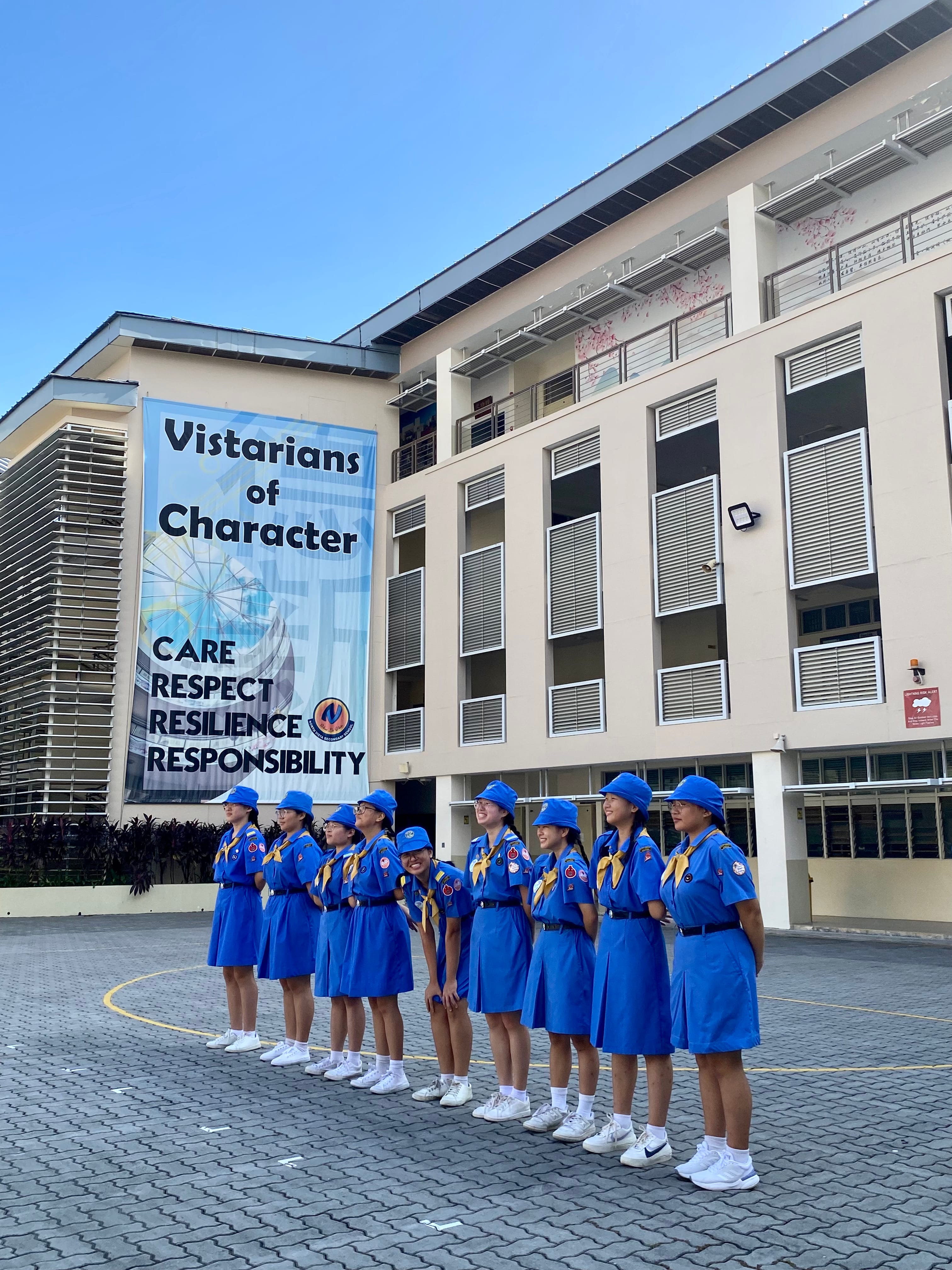 NV Girl Guides members stand in a row at the school's parade square.
