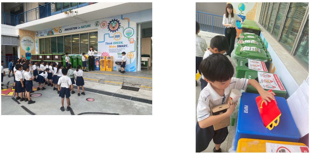 Schoolchildren line up by recycling bins; boy drops carton into paper bin beside labeled waste bins.