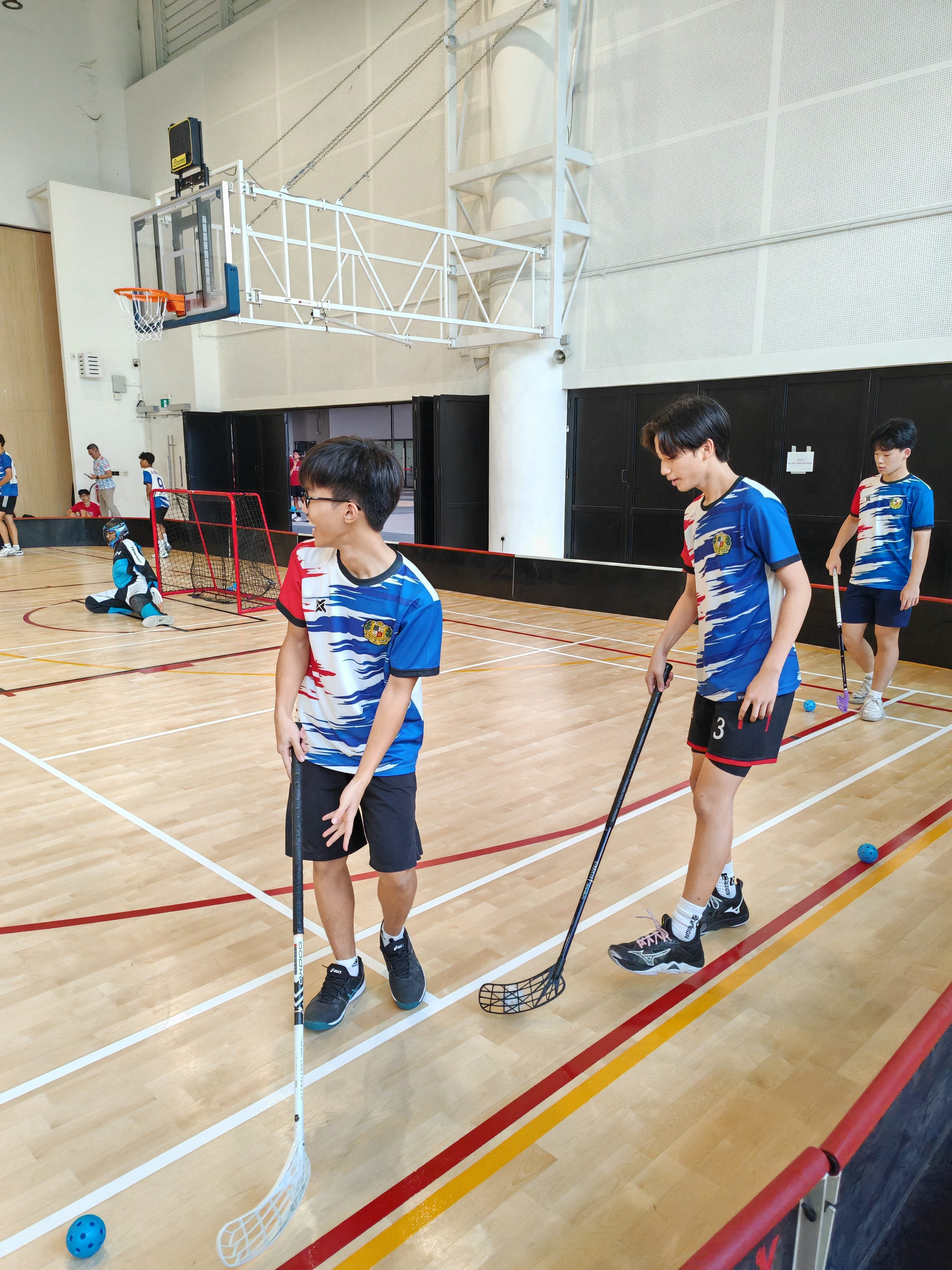 Two floorball players in training