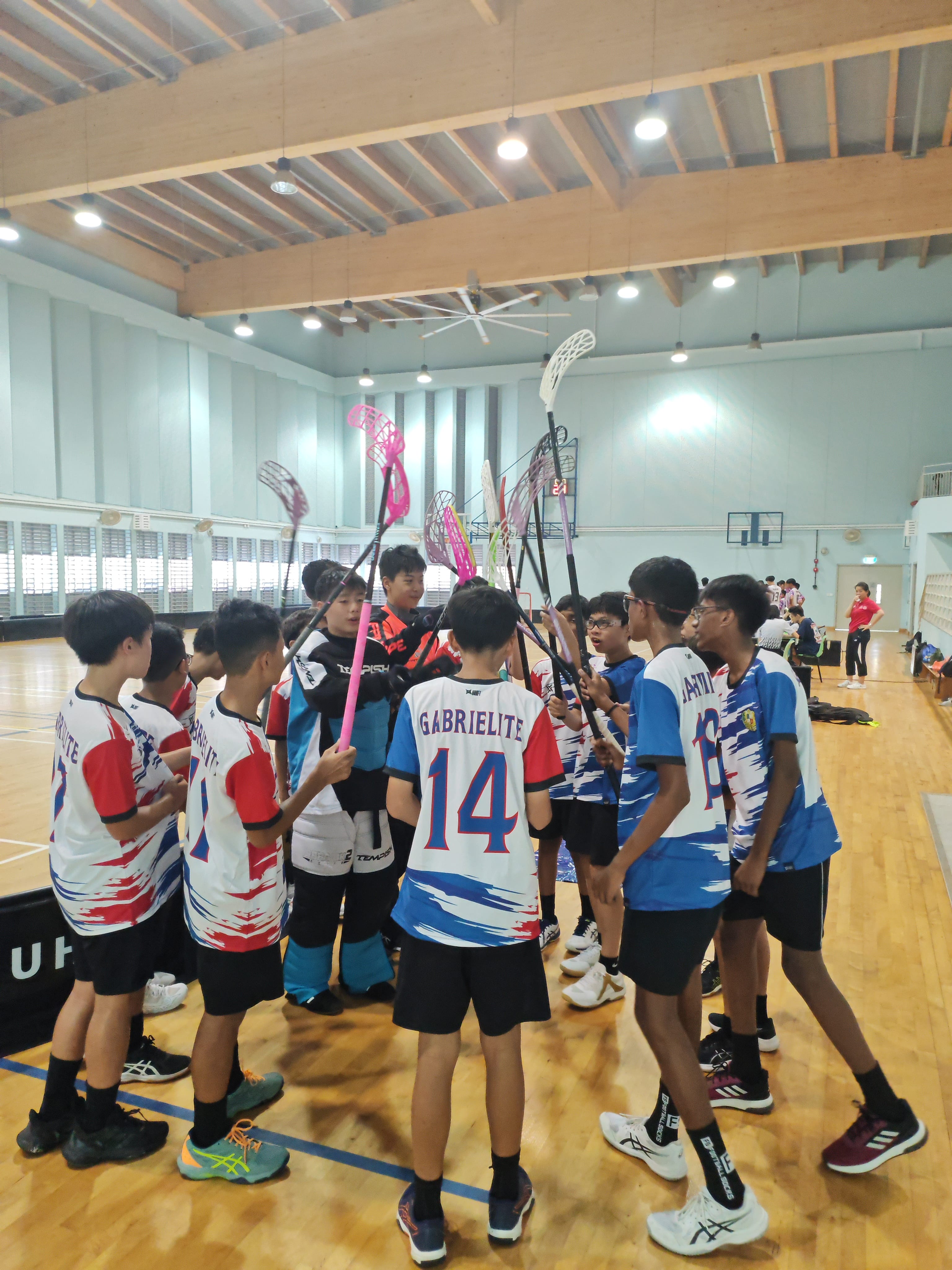 Floorball team coming together to cheer each other