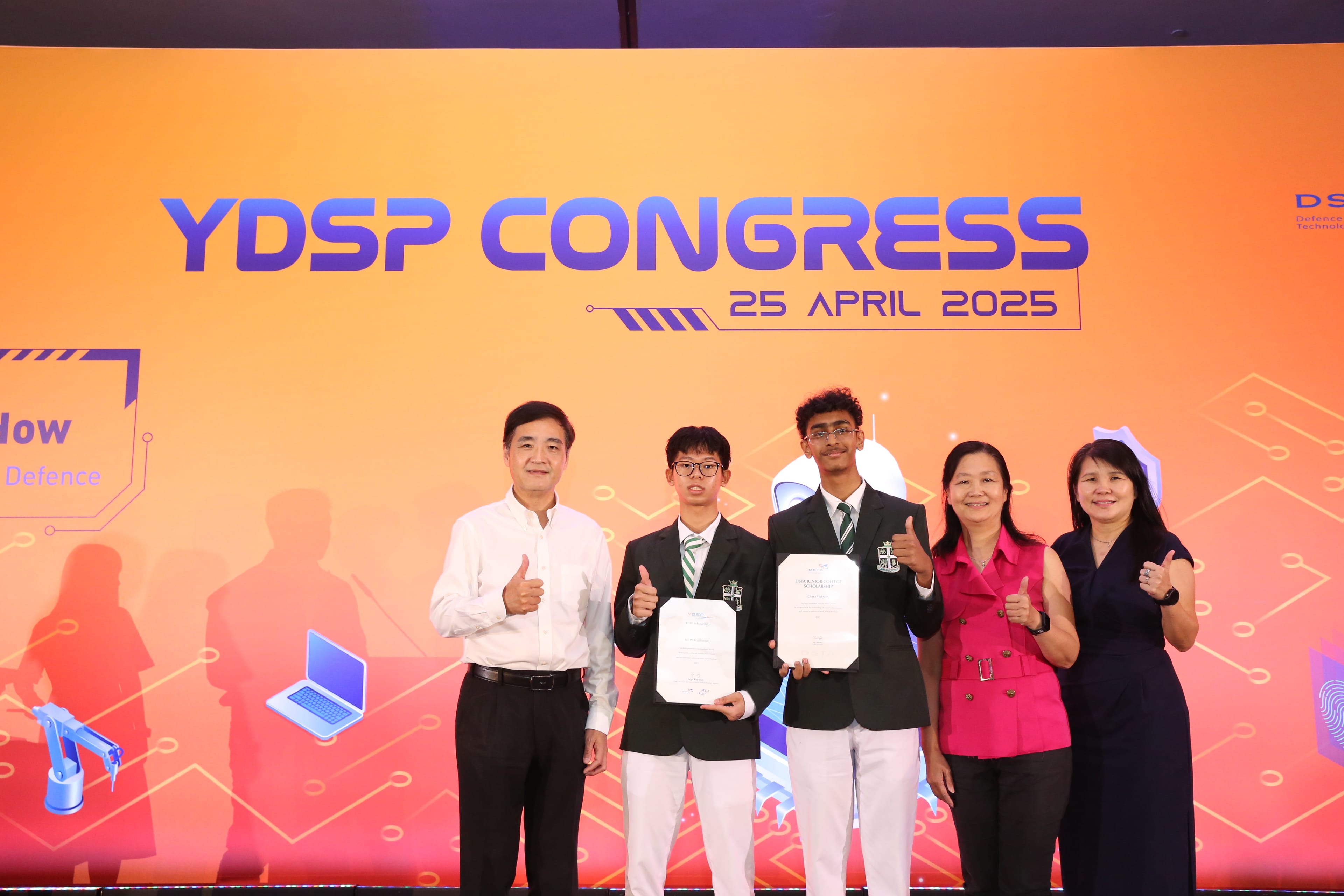 Five people pose with thumbs up at YDSP Congress on 25 April 2025, two students holding certificates.