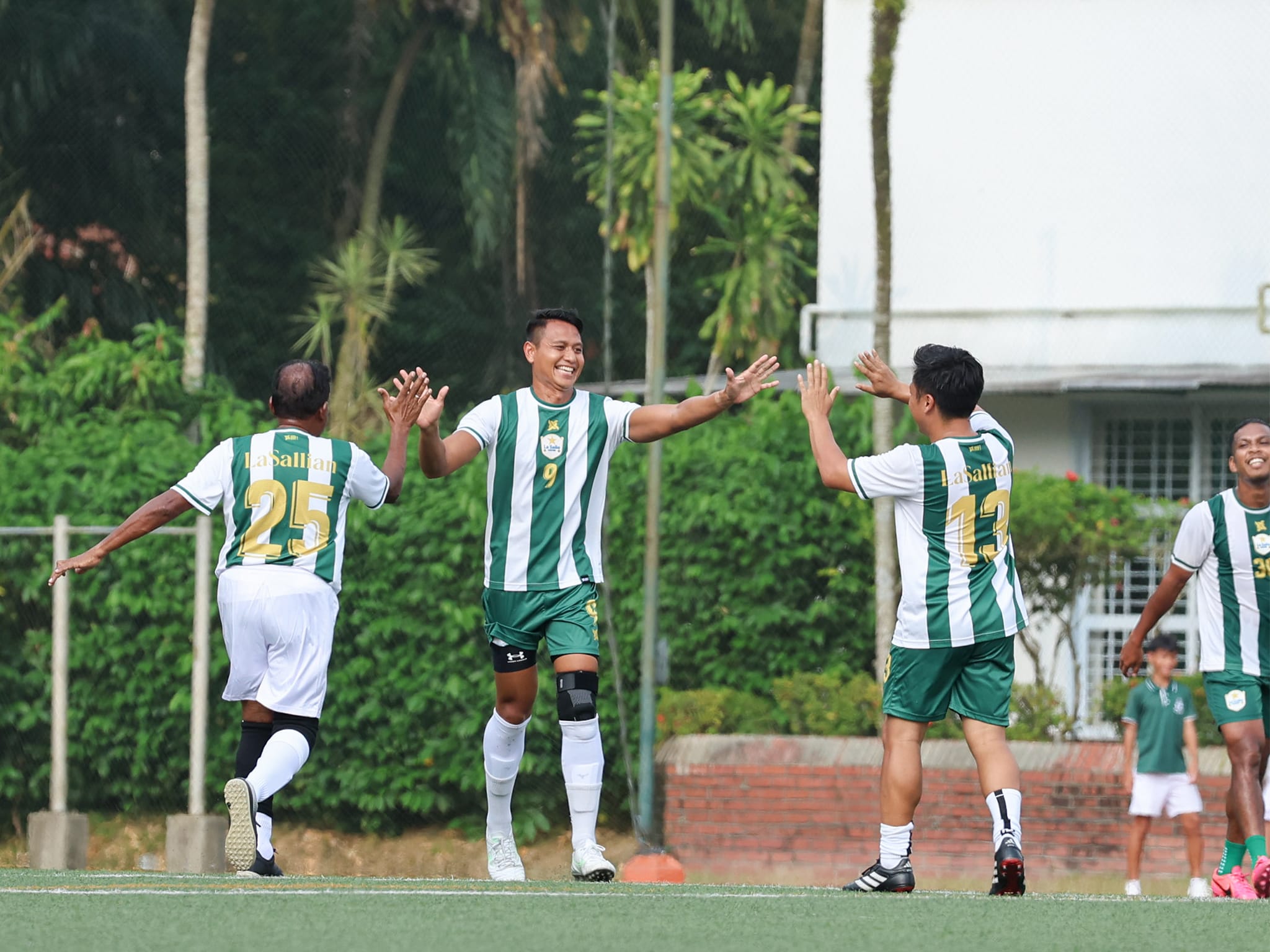 Mr Syai and his fellow teachers on the field