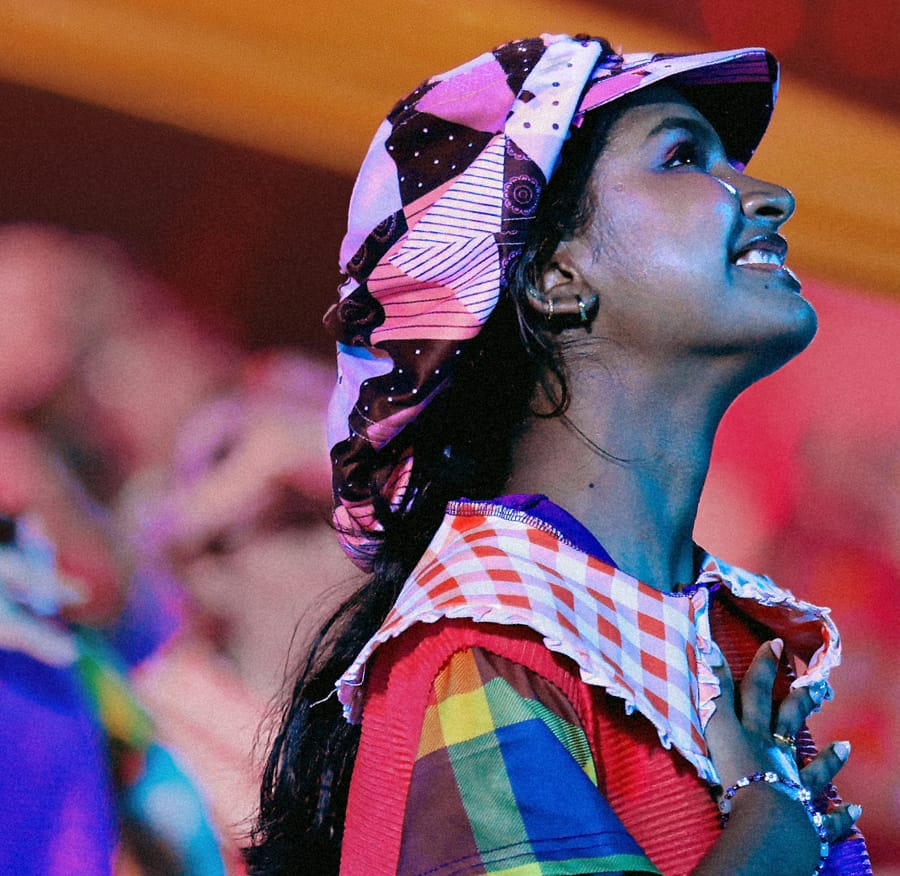 Performer in colourful costume looking up during an NDP show