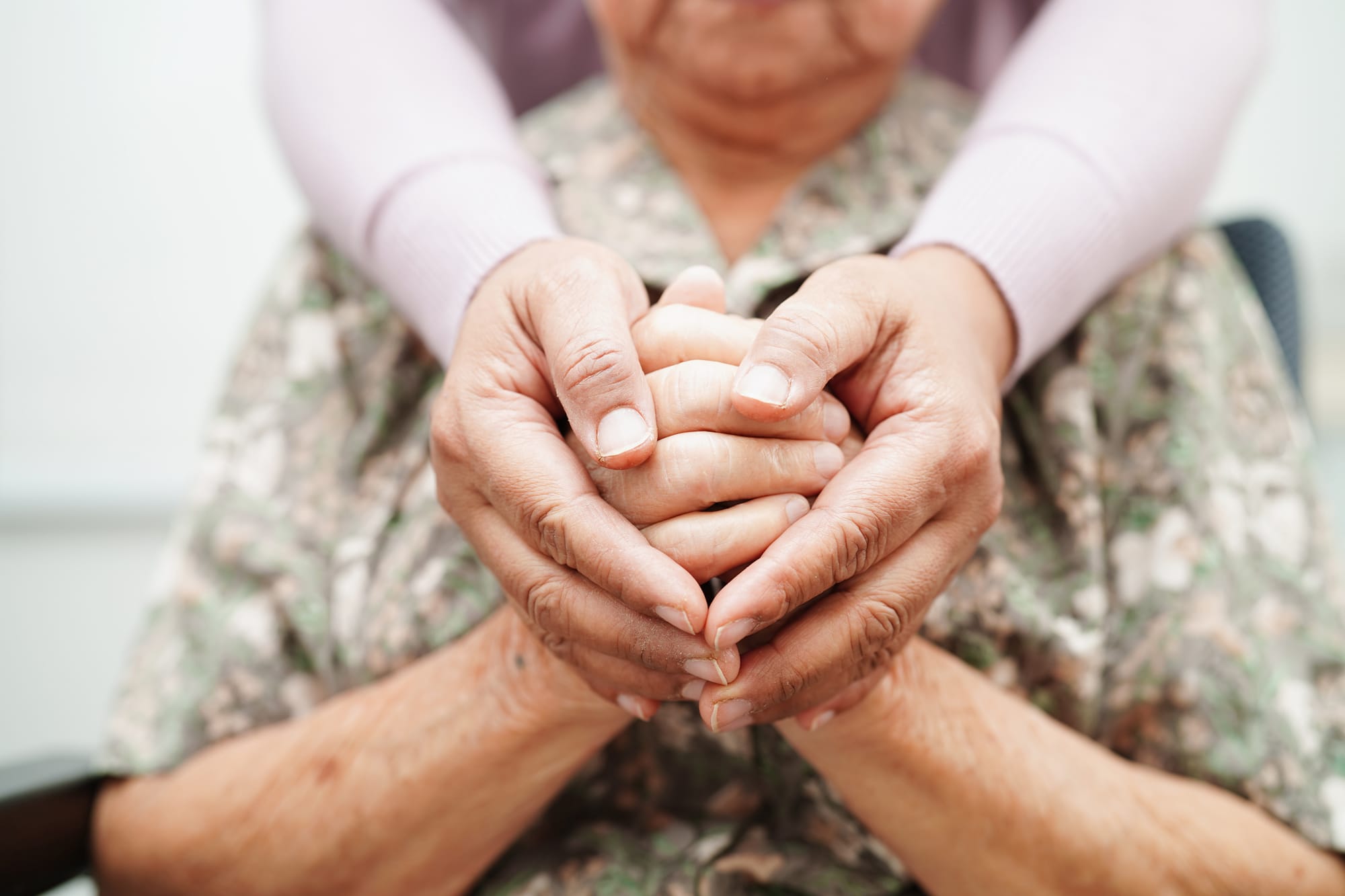 Volunteer holding hands Asian elderly woman, help and care in home.