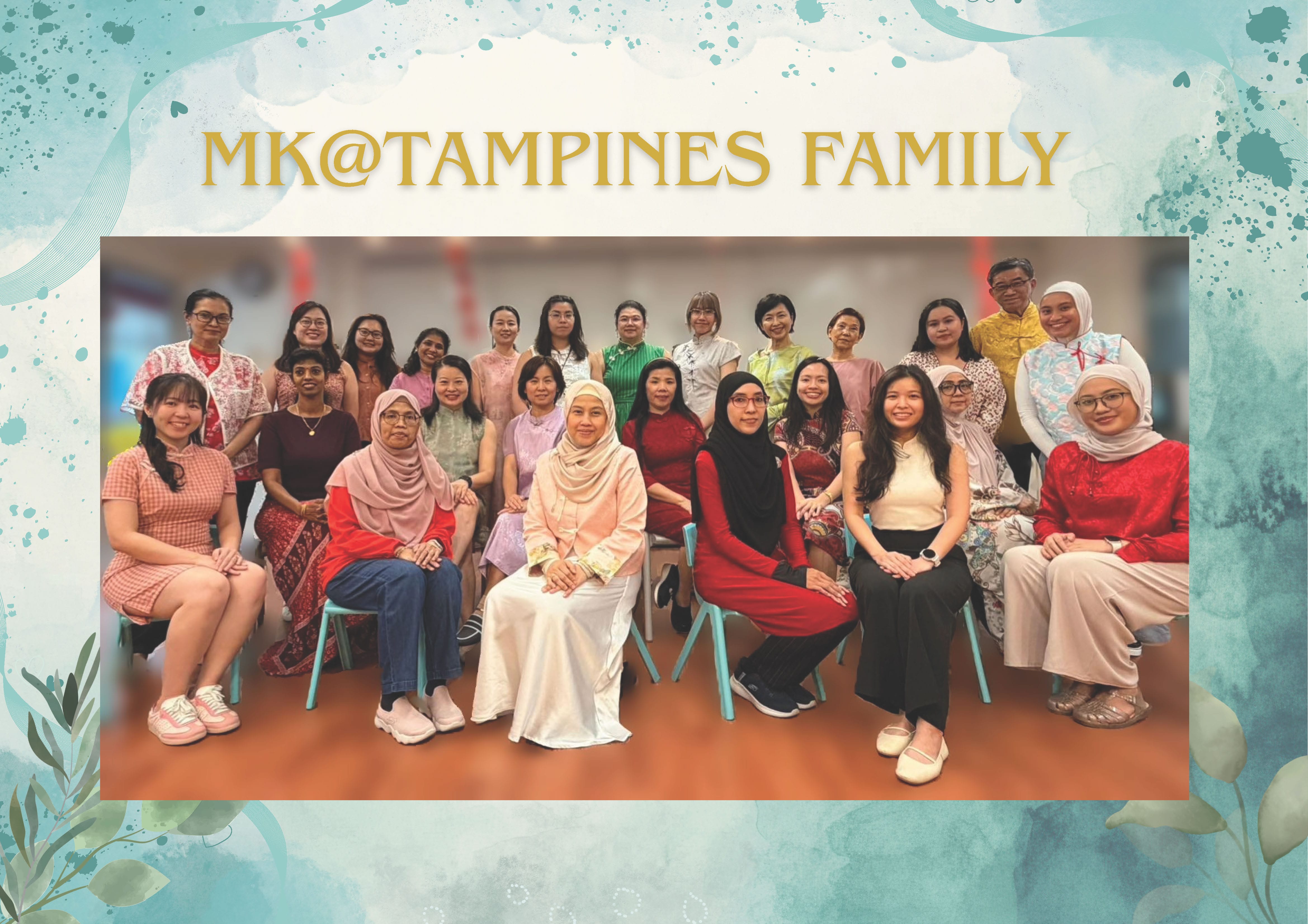 Group photo of about 20 people in colorful traditional outfits under the text MK@Tampines Family.