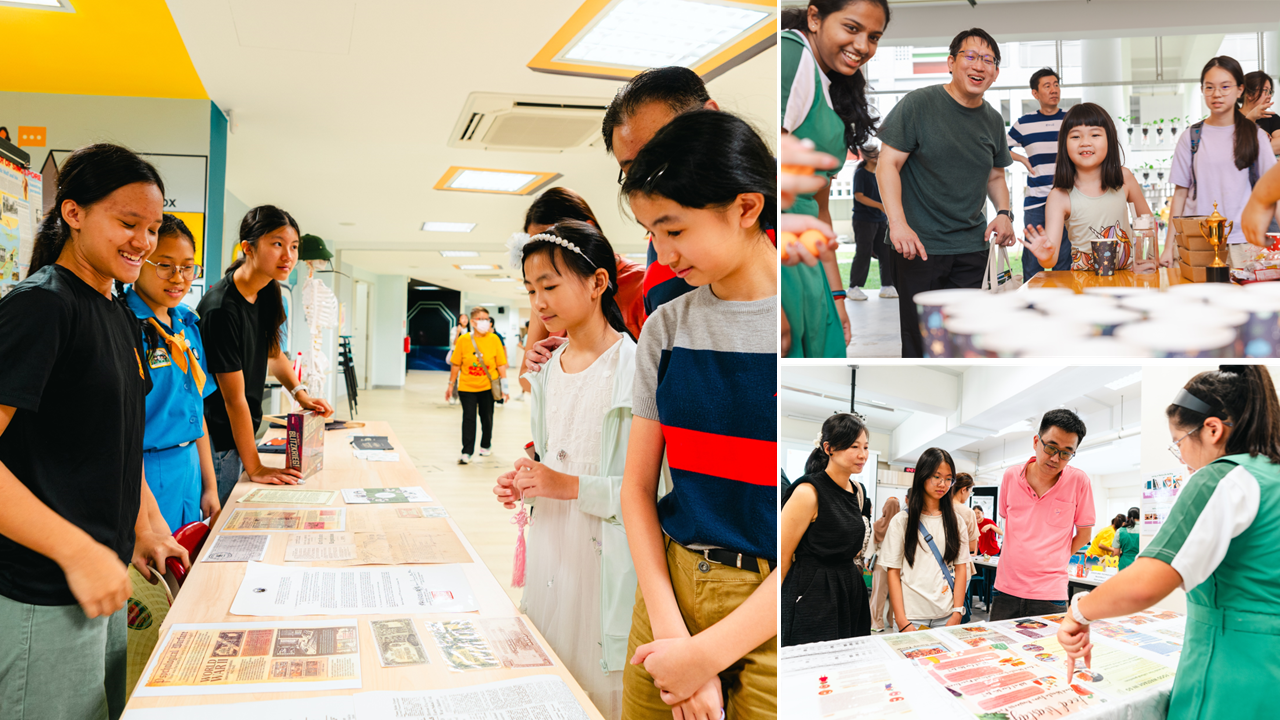 Children and adults browse display tables with printed materials and exhibits at an indoor school open house event.