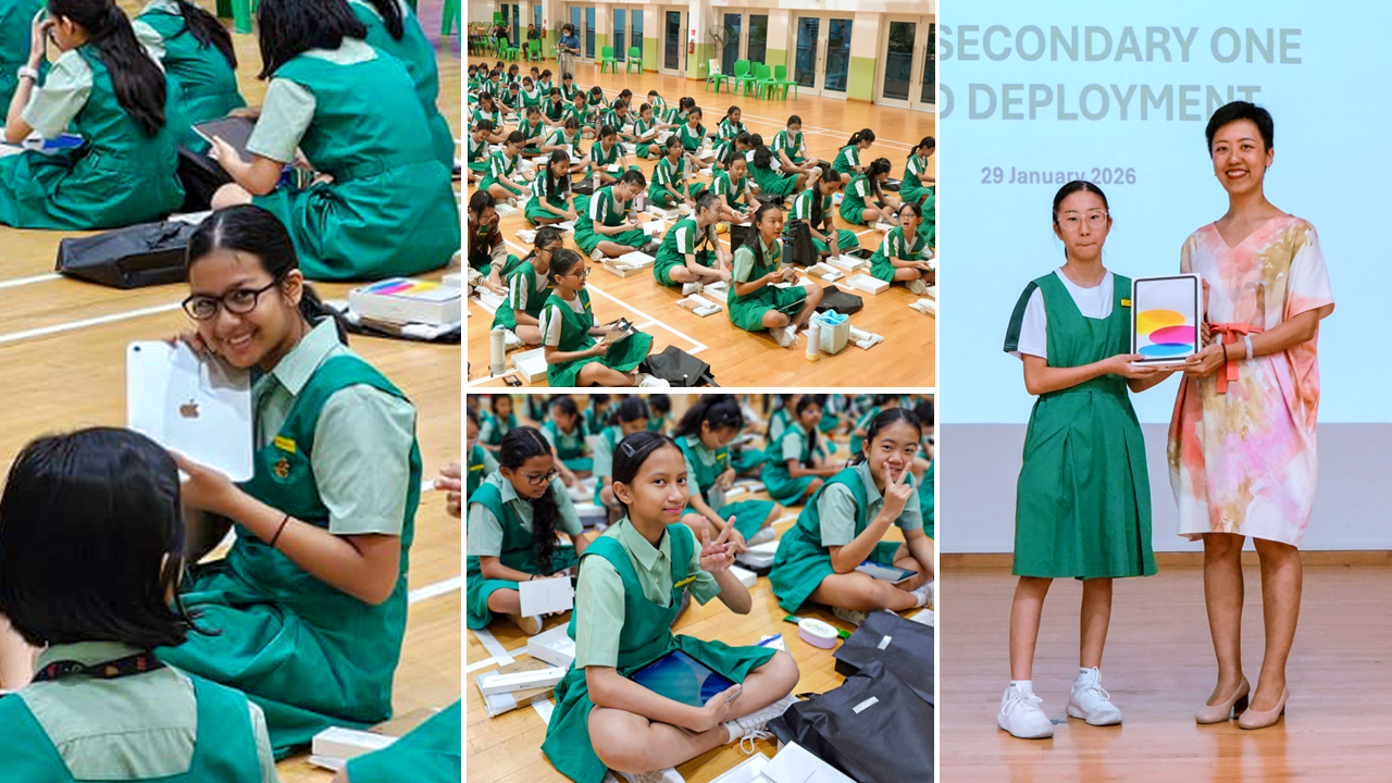 Girls in green uniforms sit on a gym floor unboxing tablets at a Secondary One iPad deployment event on 29 January 2026.