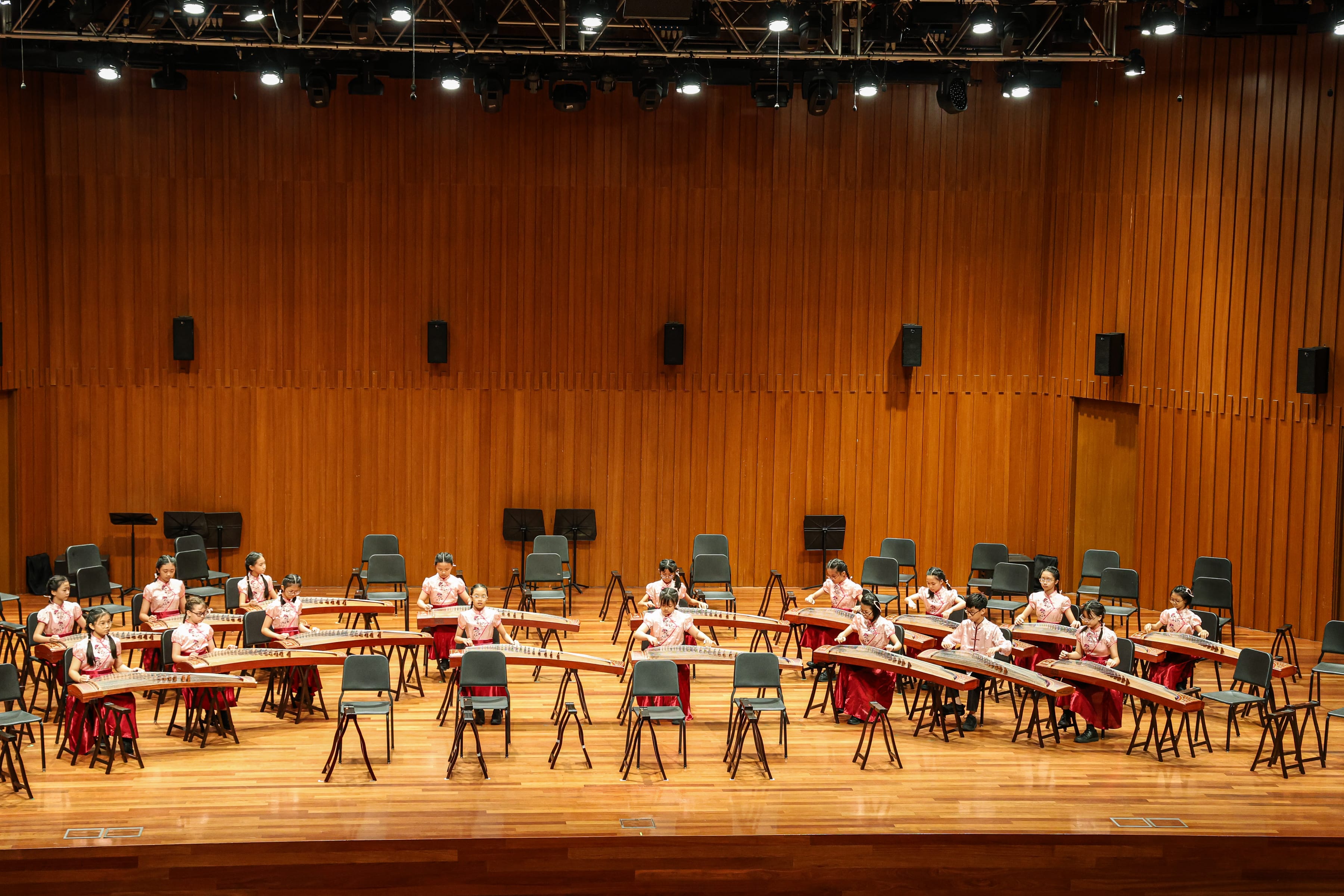 Our Guzheng performers in red and pink traditional outfits giving a stunning performance.