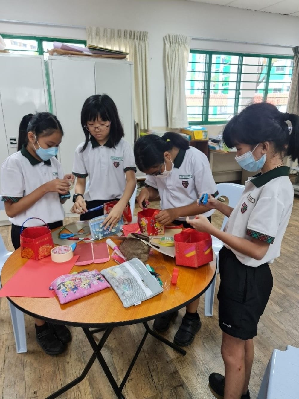 Four students working together to create beautiful lanterns.